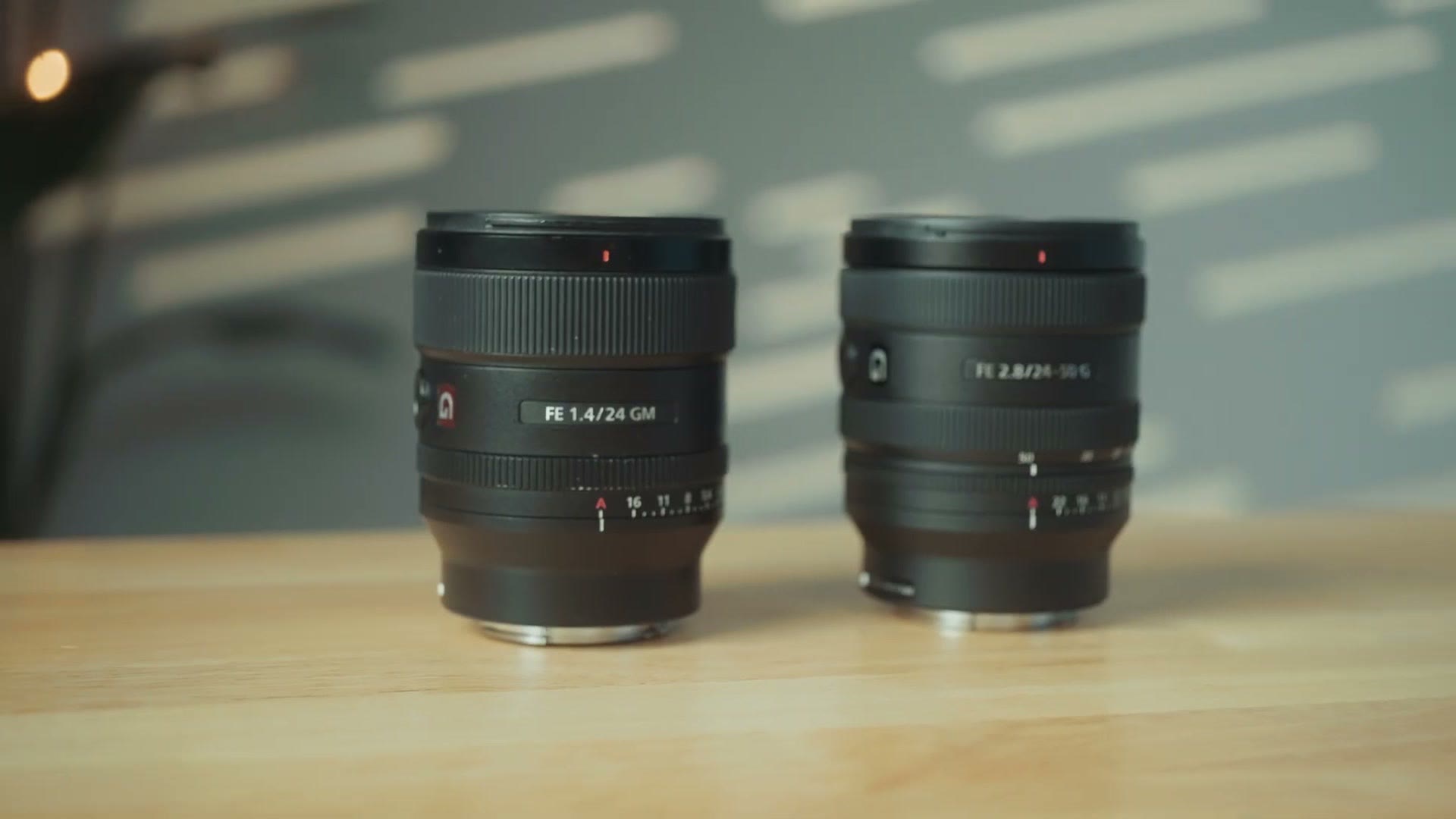 Sony 24mm f/1.4 GM next to the Sony 24-50mm f/2.8 G on a table