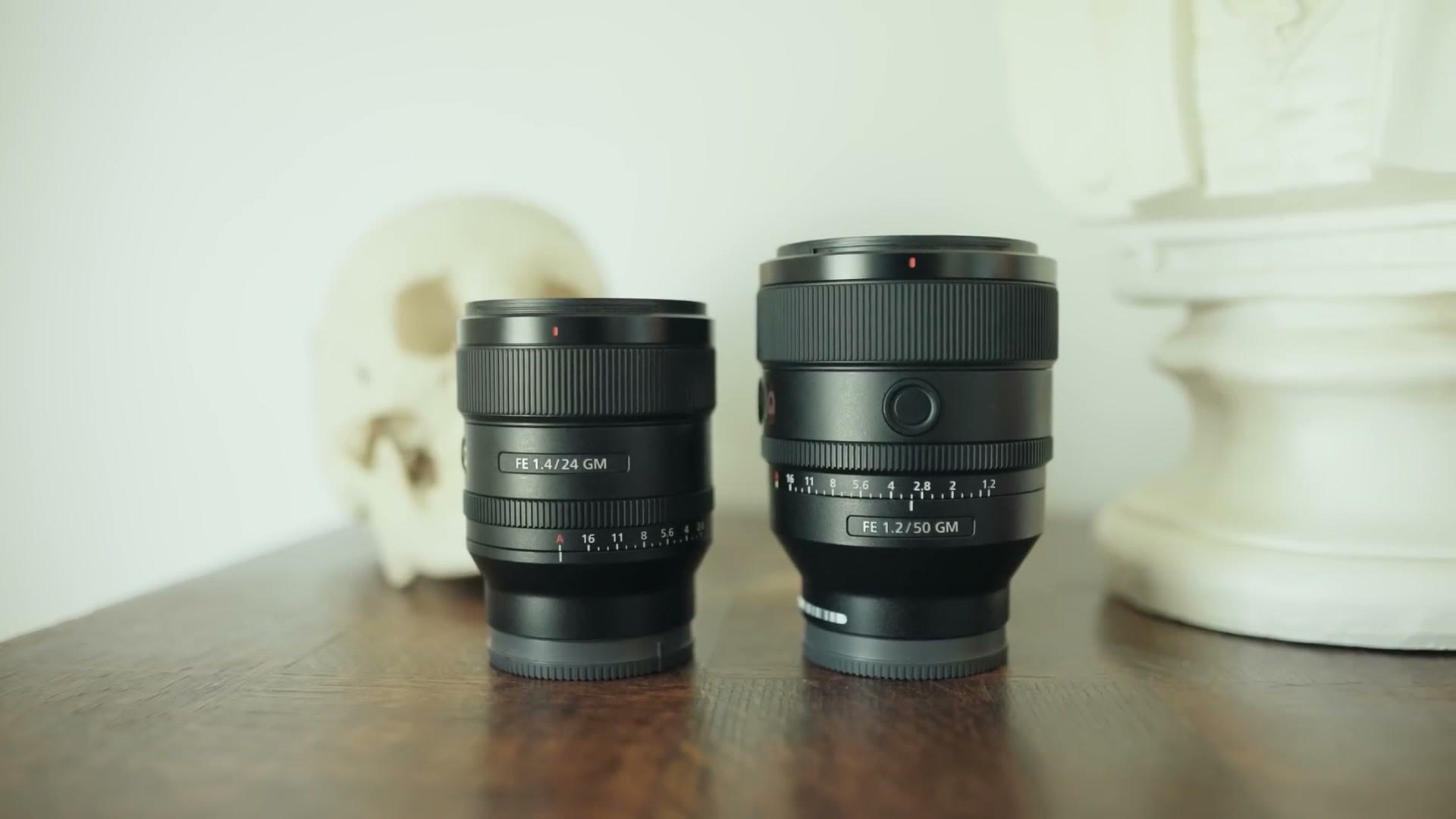 The Sony 24mm f/1.4 GM standing next to the larger Sony 50mm f/1.2 GM