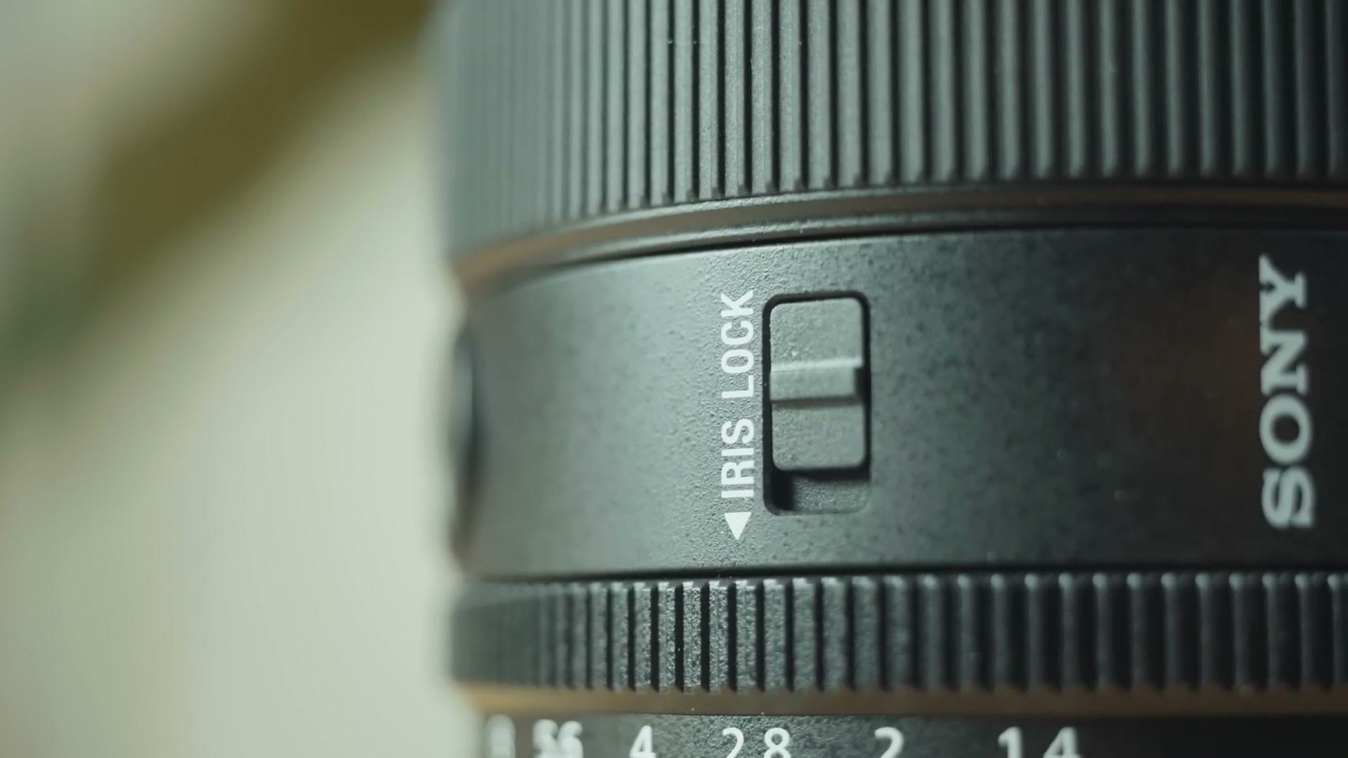Close up of the iris lock switch on the side of the Sony 50mm f/1.4 GM