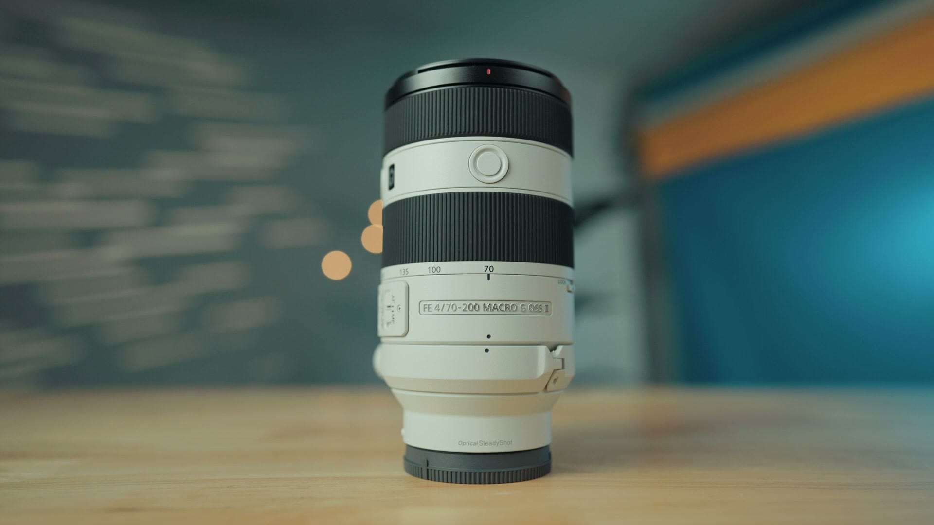 Sony 70-200mm F4 Macro G OSS II lens standing on a wooden table