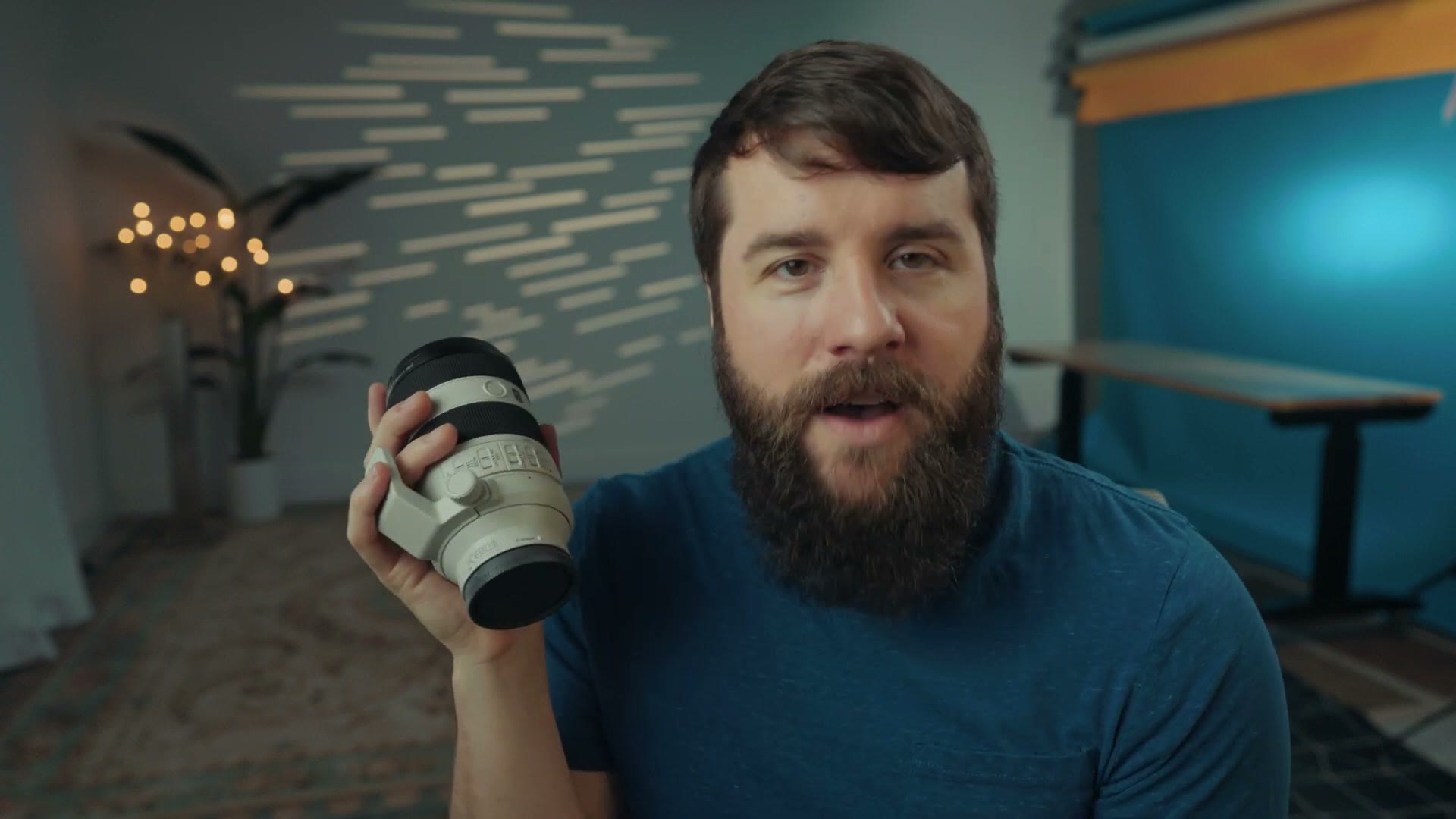 Matt Johnson holding the Sony 70-200 F4 II lens while talking to camera