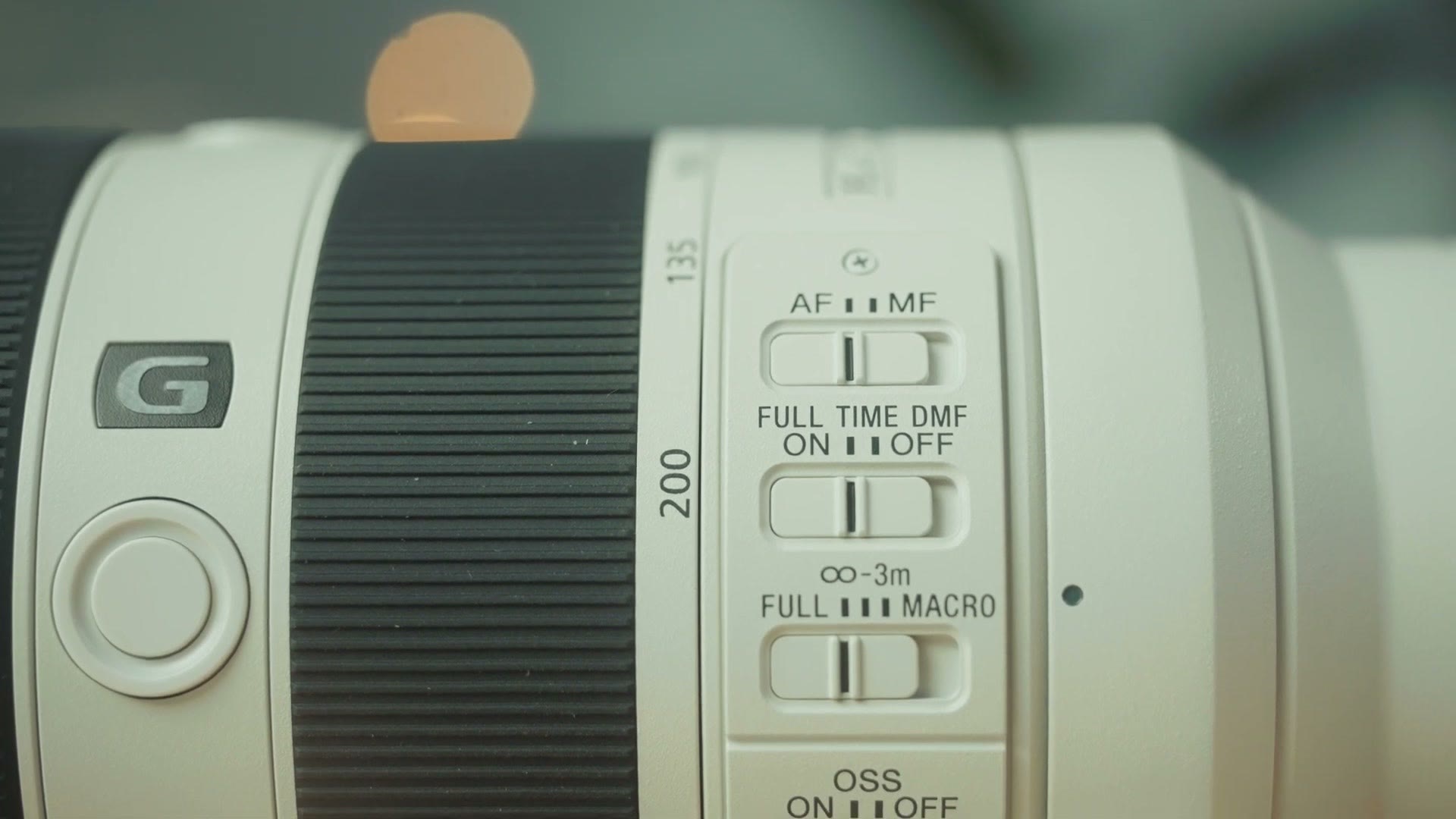 Close up of the switch panel on the Sony 70-200 F4 II showing AF MF, full time DMF, full macro and OSS switches