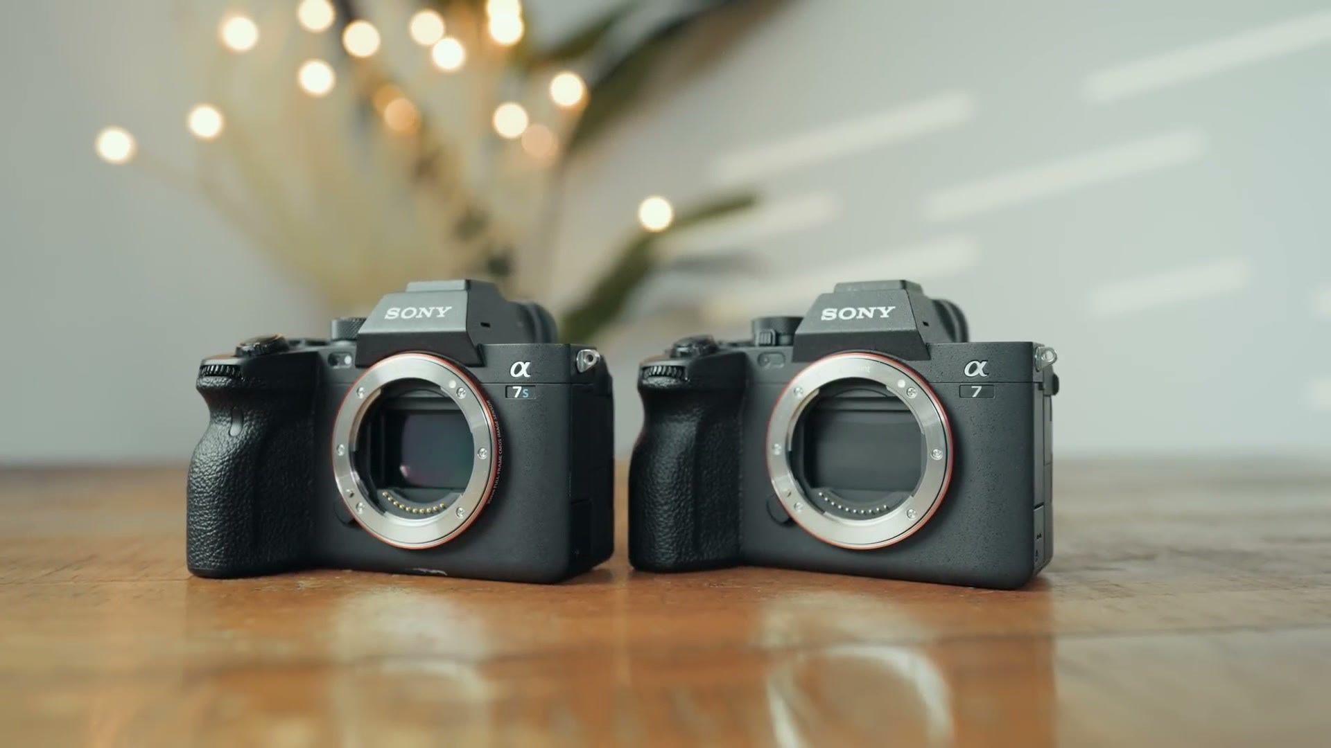 Sony a7 IV and Sony a7S III bodies sitting side by side on a wooden table