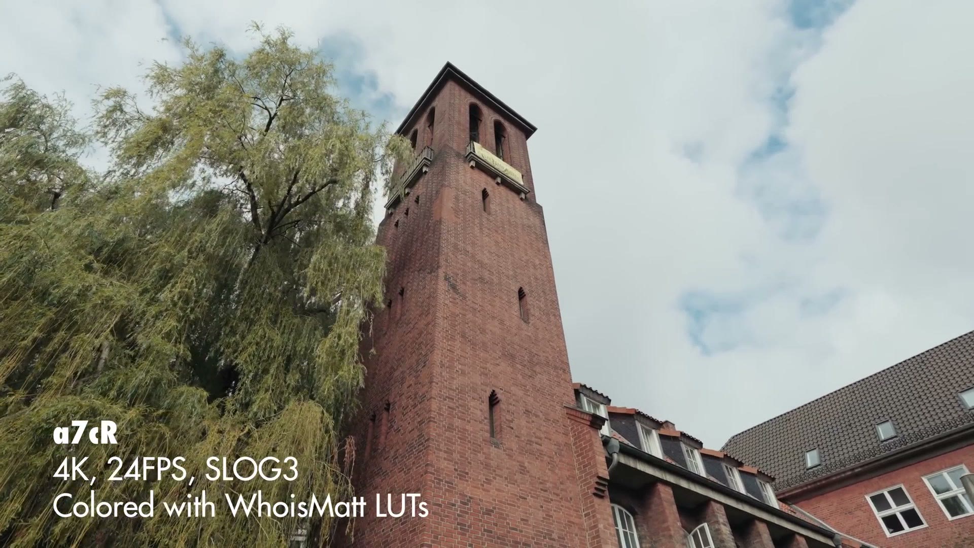 A brick tower and trees shot on the Sony a7C R at 4K 24fps in S-Log3