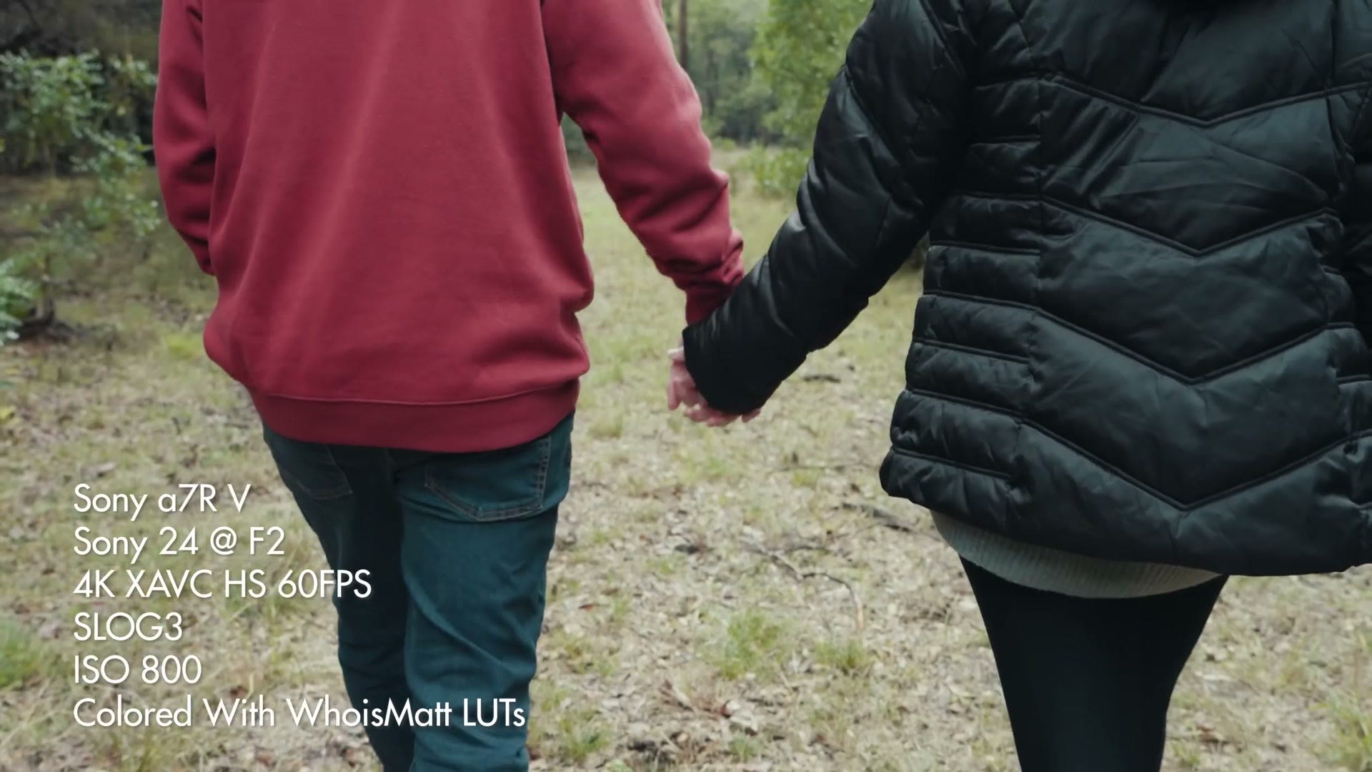 A couple holding hands walking away from camera, filmed on the a7R V with a Sony 24mm at F2