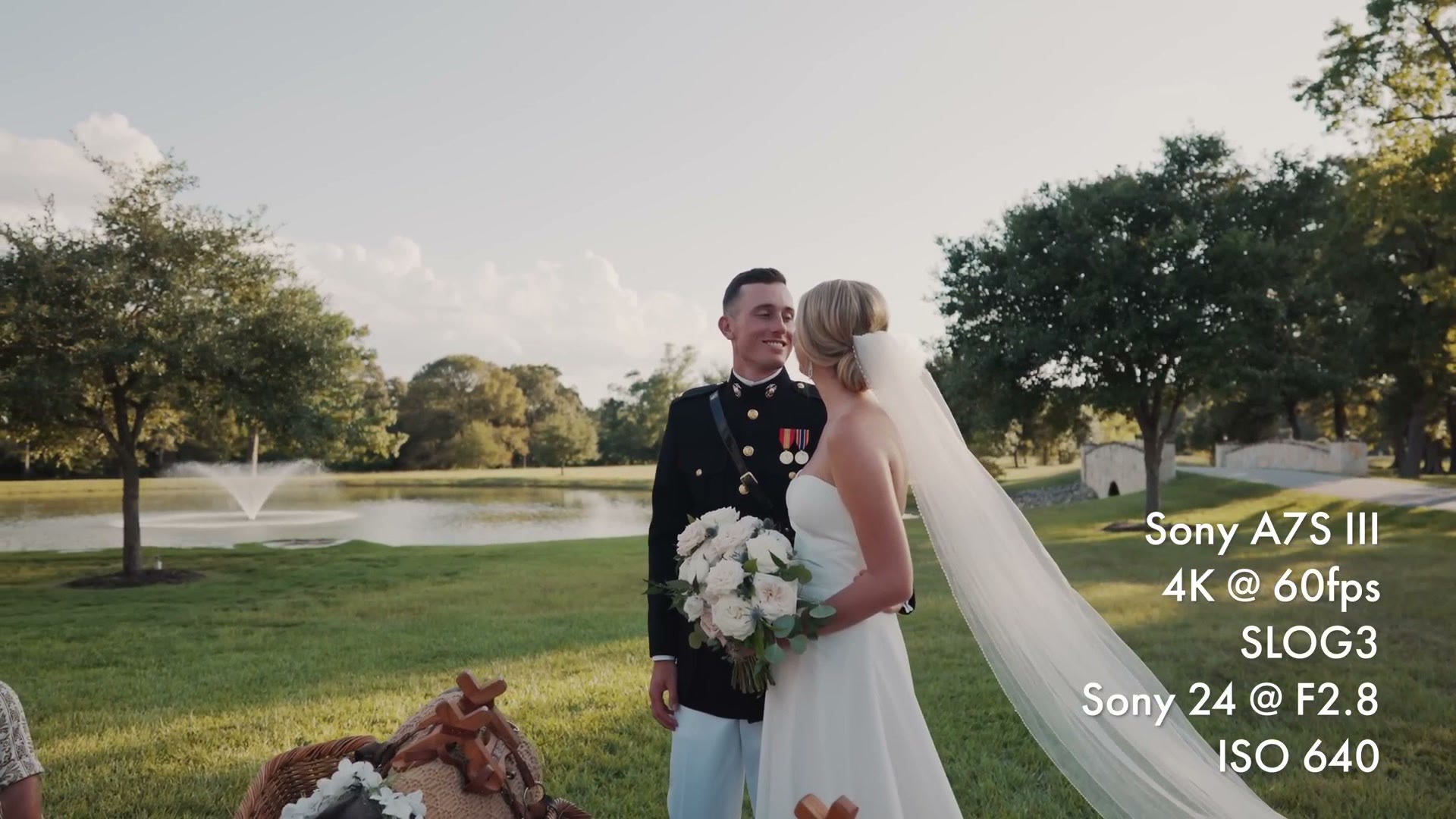 A bride and groom by a lake at golden hour, filmed at 4K 60 frames per second in SLOG3