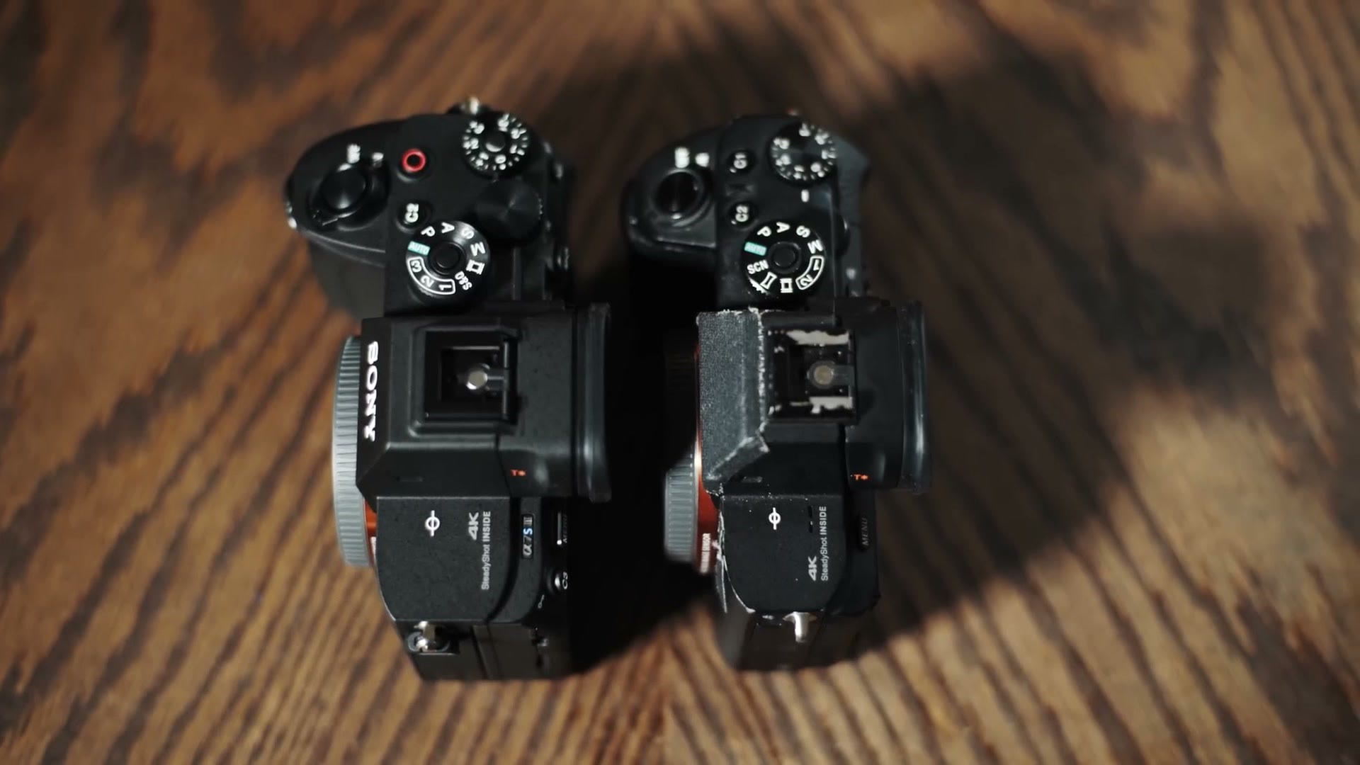A Sony a7S III and a7S II sitting side by side, seen from above, showing the size difference