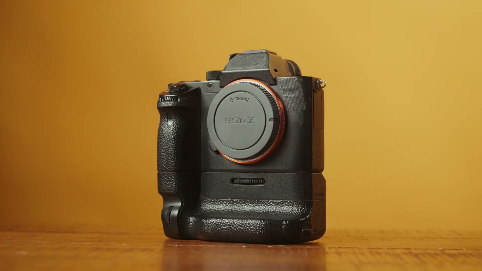 A Sony camera fitted with a vertical battery grip