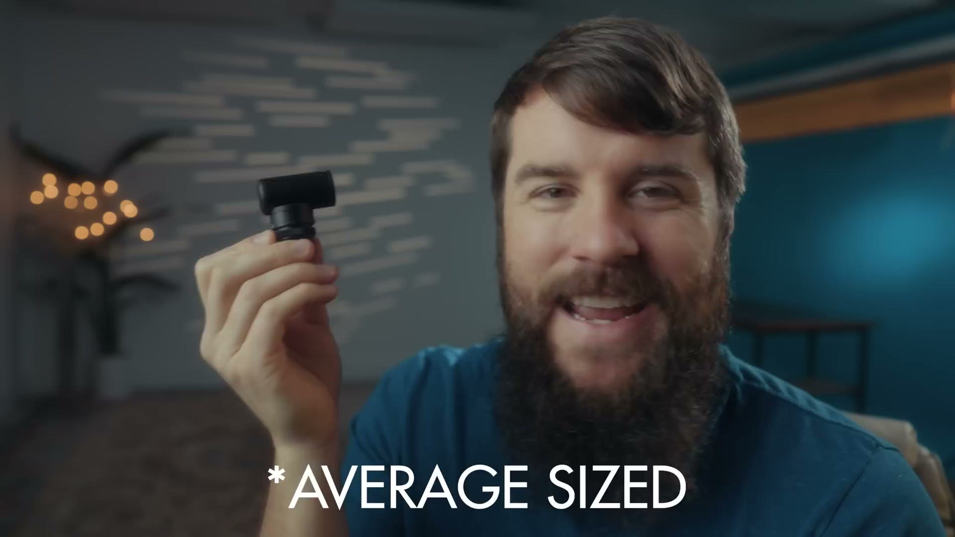 Matt Johnson holding the tiny Sony ECM-G1 microphone with an on screen caption reading average sized