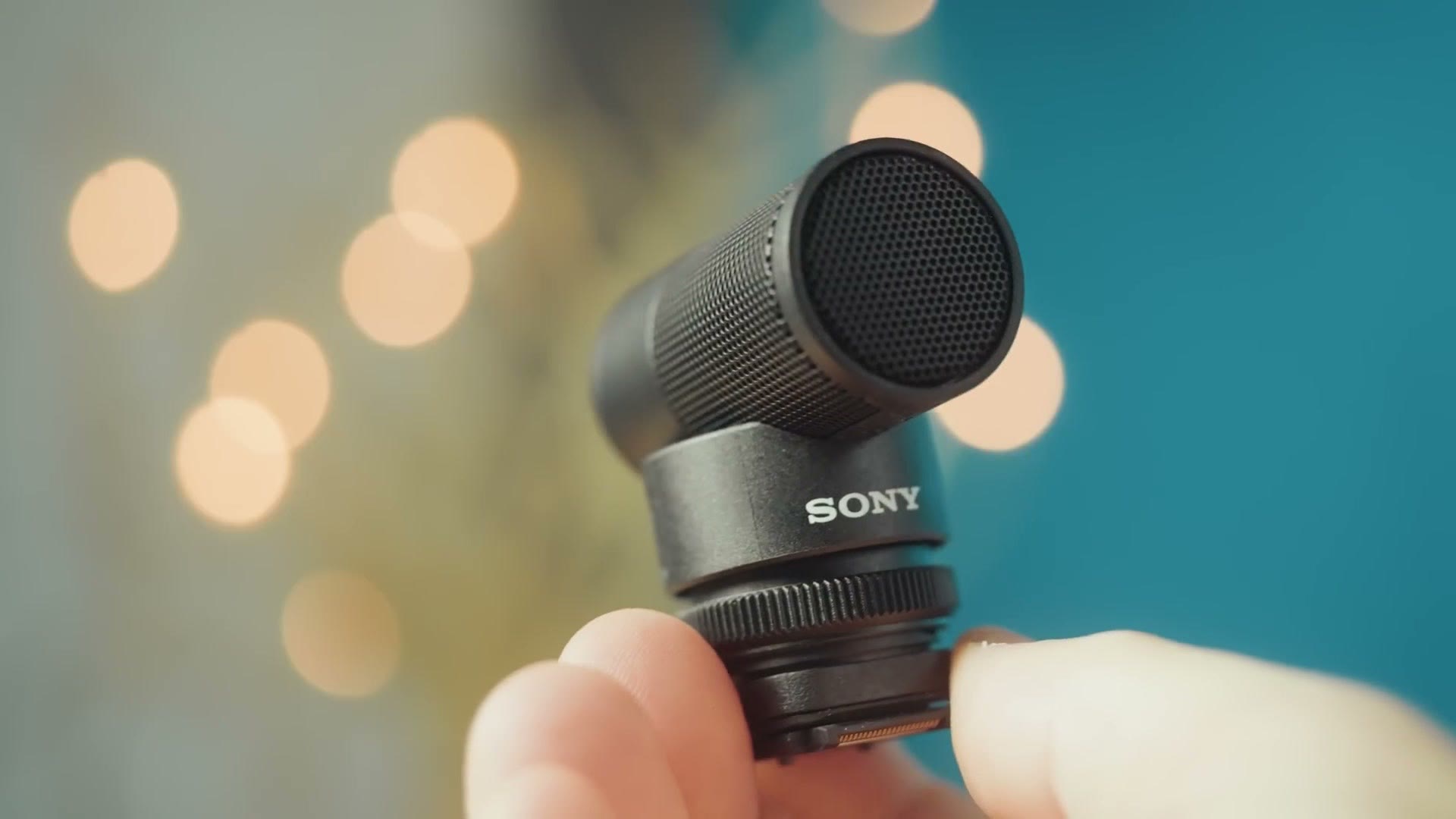 Close up of the Sony ECM-G1 capsule held between two fingers
