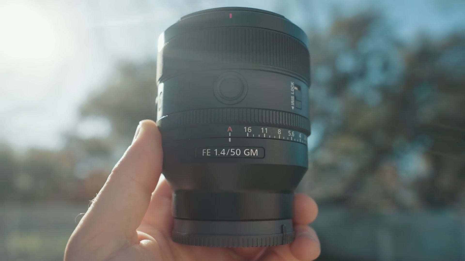 Close up of the Sony FE 1.4/50 GM lens held in one hand