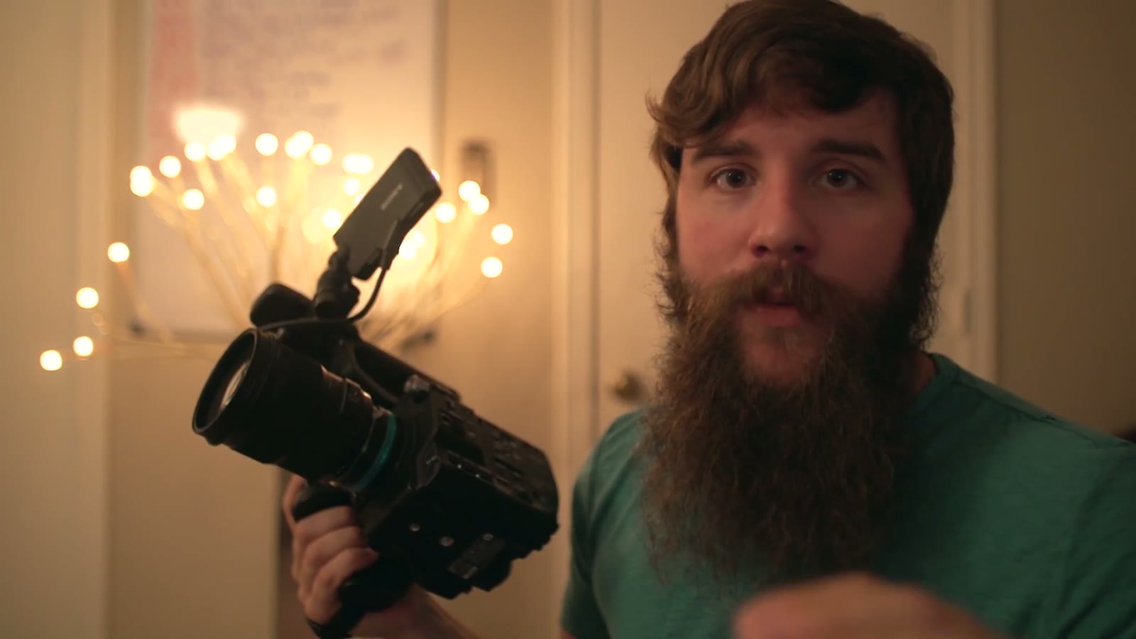 Matt with a calmer expression holding the FS5 to the side, a hand gesture blurred in the foreground