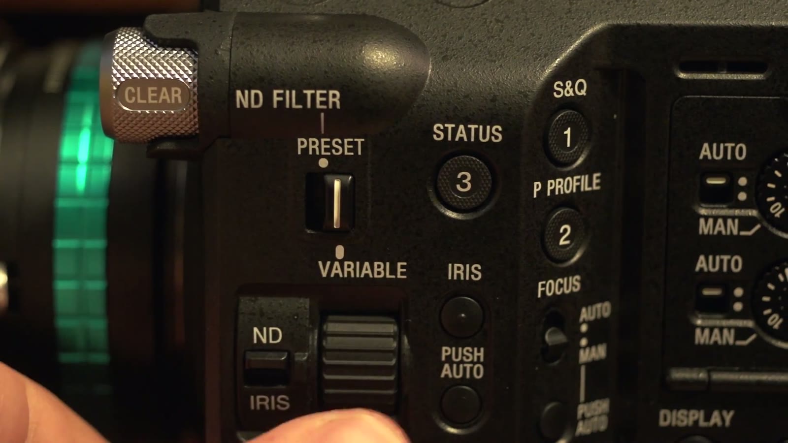Close-up of the FS5 side panel: ND FILTER switch set to Preset, plus Status, Iris, Focus, and Auto/Man switches labeled