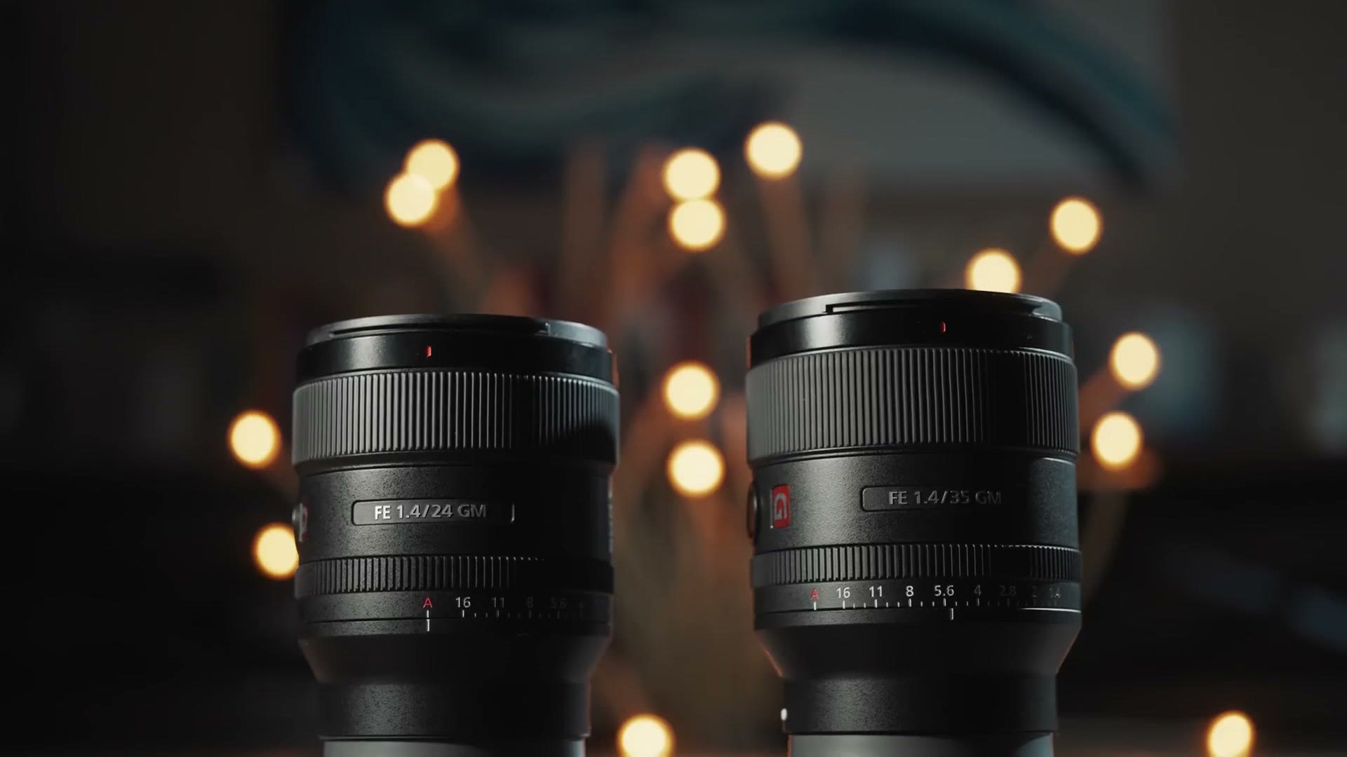 Sony FE 24mm f1.4 GM and FE 35mm f1.4 GM standing side by side on a table