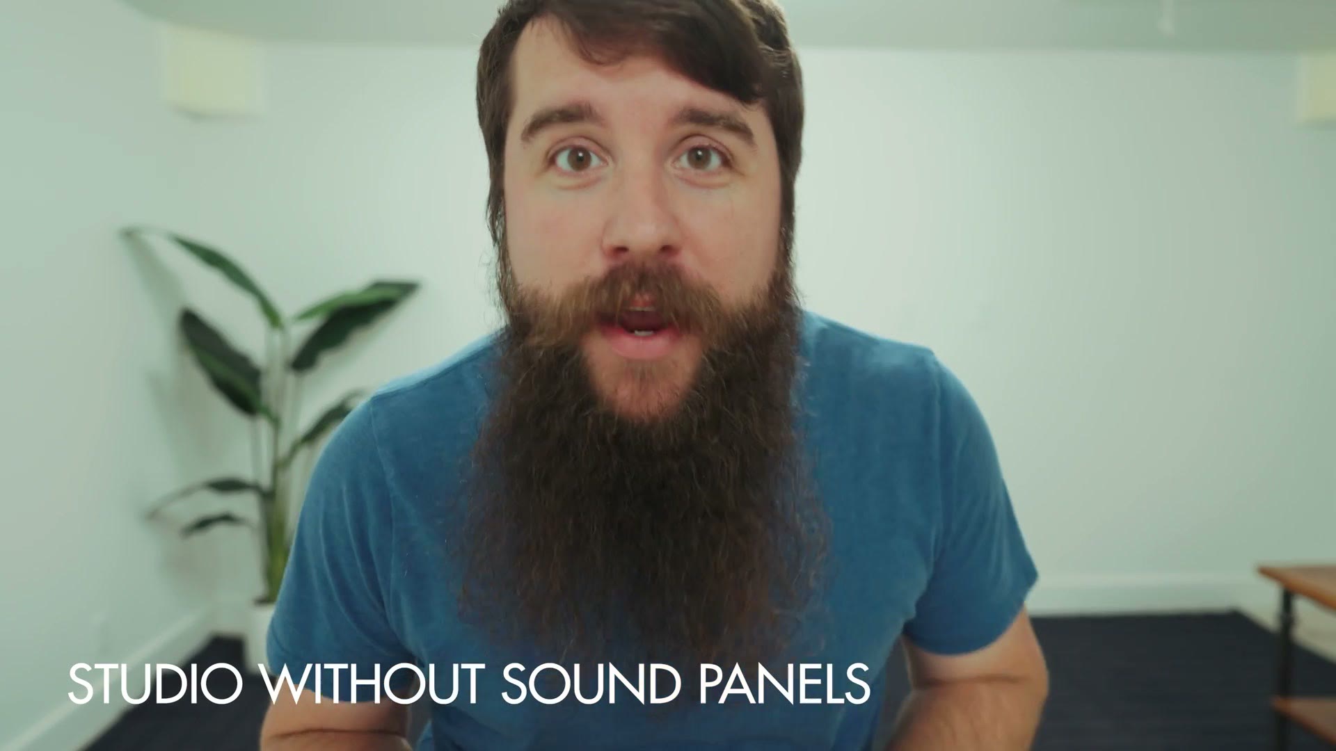 Matt in the untreated studio with a caption reading studio without sound panels