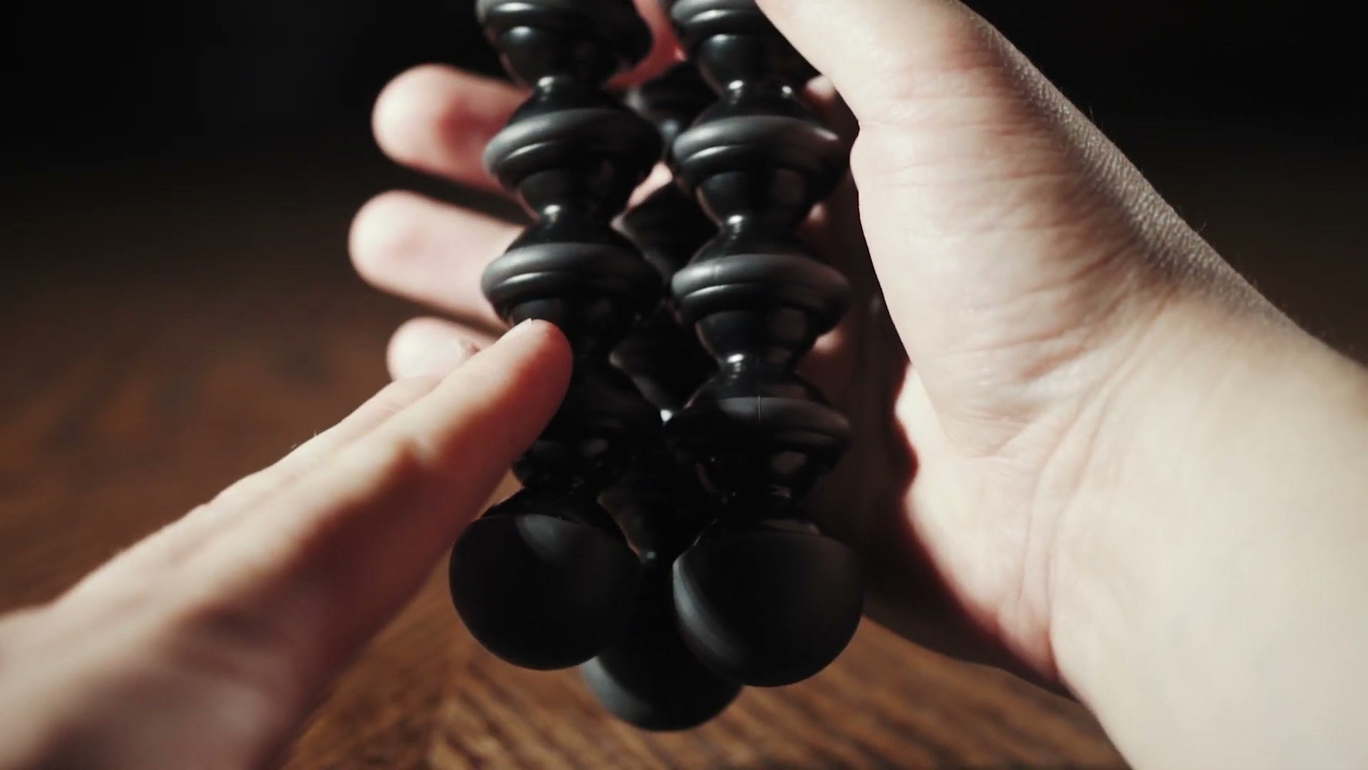 A hand wrapped around the ball joints of a Gorillapod leg, showing how the grip works