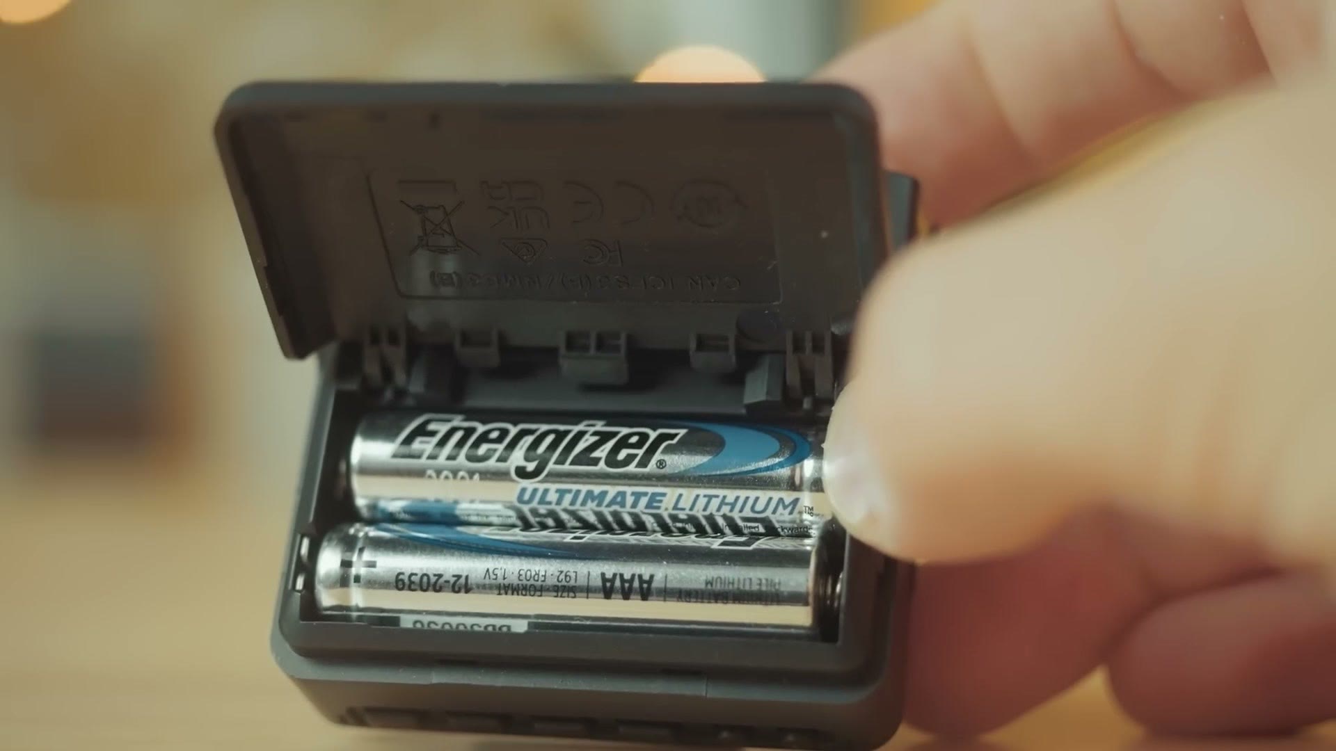 The Tascam DR-10L Pro battery door open showing two AAA lithium batteries
