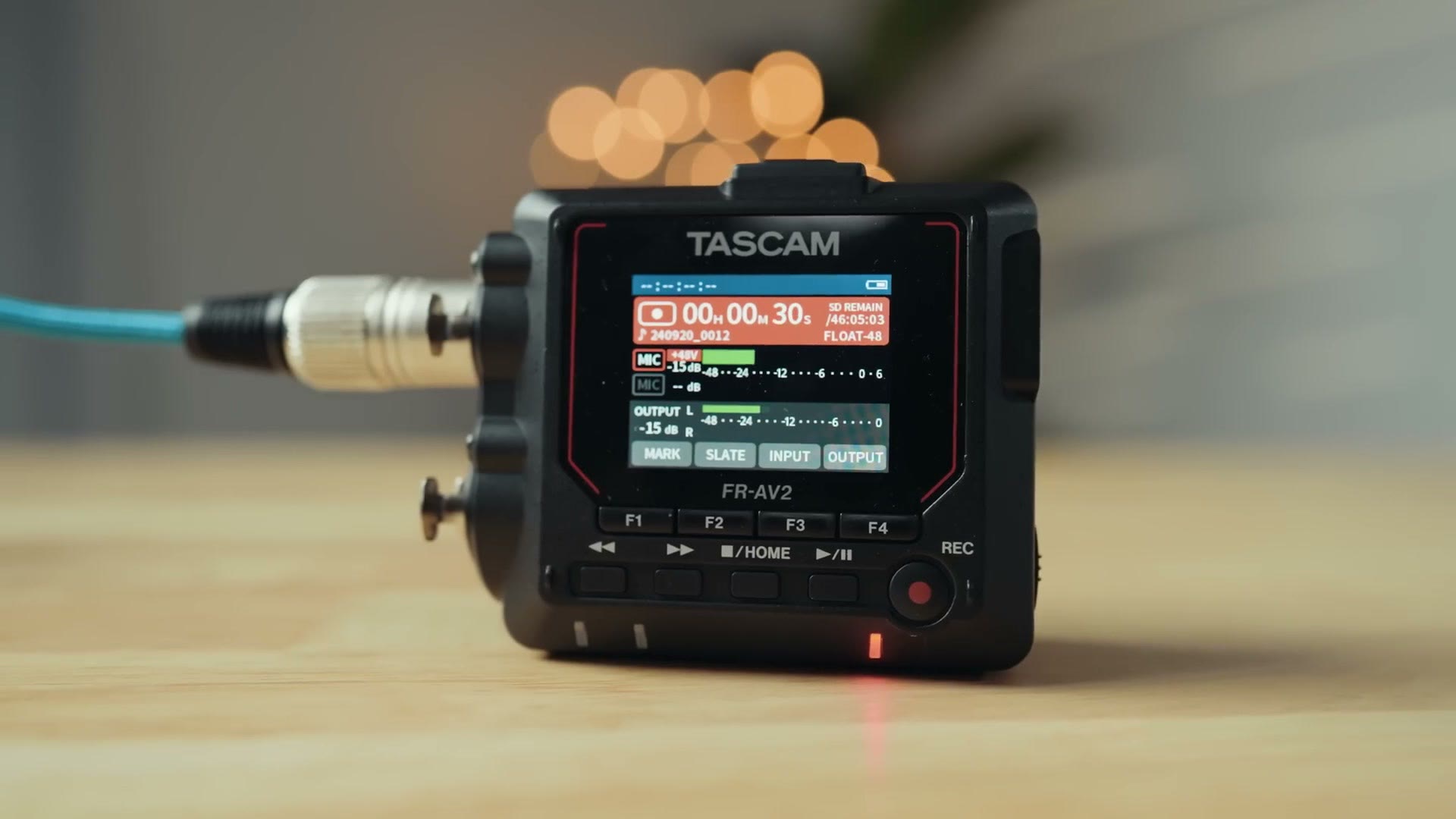 The Tascam FR-AV2 color screen showing recording levels and timecode