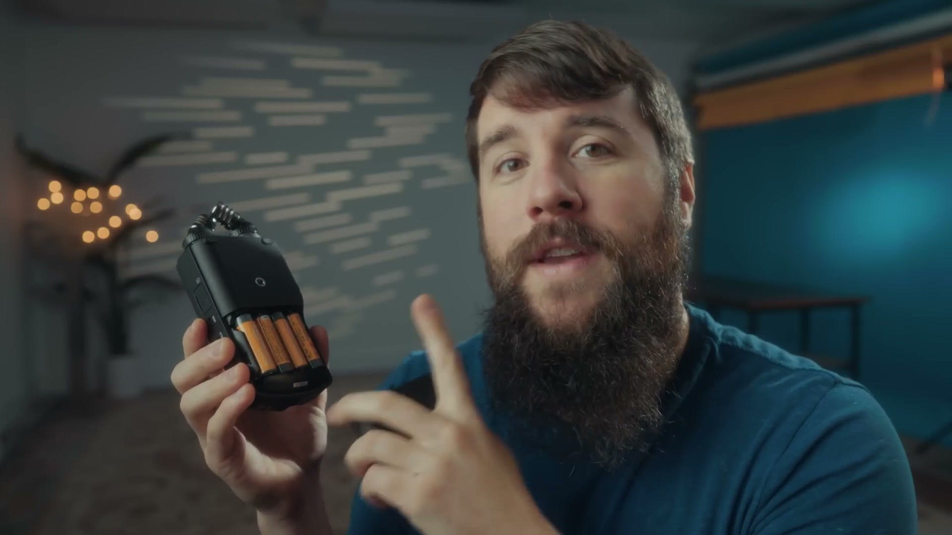 The battery door of the Tascam X6 open showing four AA batteries