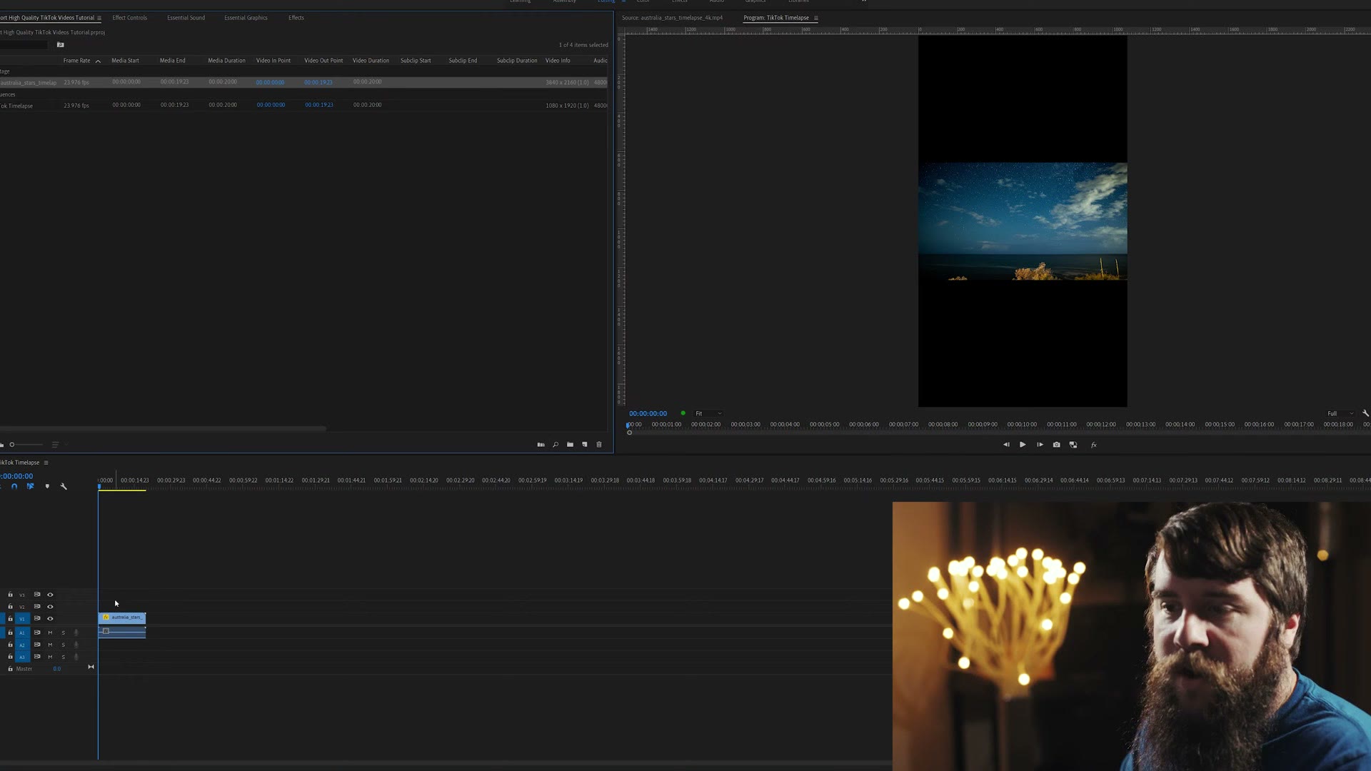 A Premiere Pro program monitor showing a horizontal timelapse of a night sky floating in a vertical frame with thick black bars above and below it.
