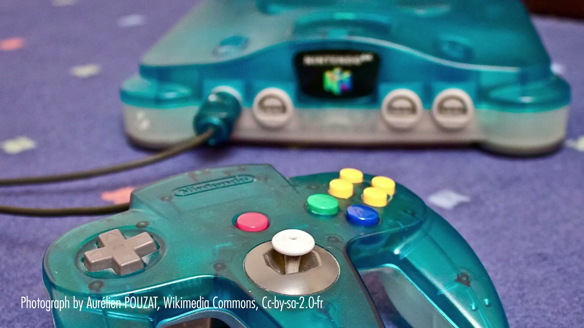 A translucent blue Nintendo 64 console and controller