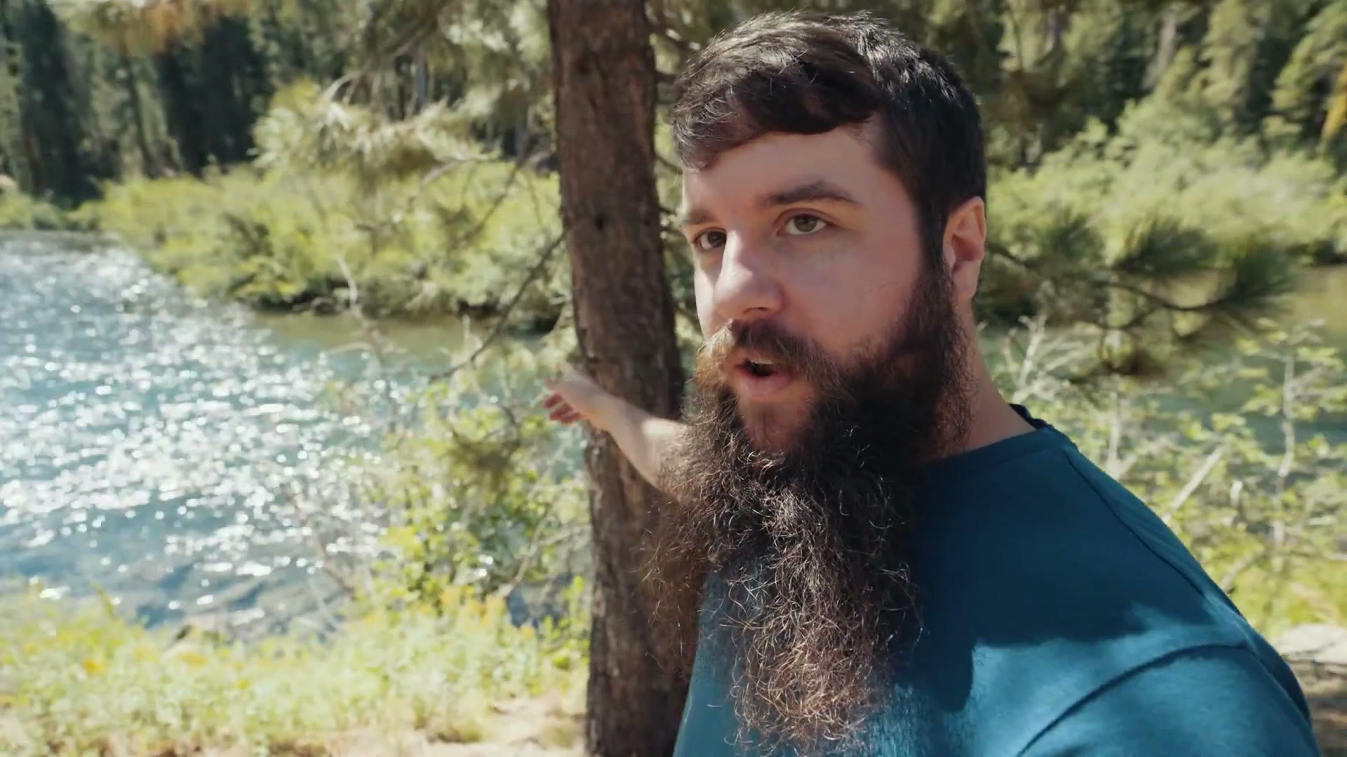 Matt Johnson standing beside the Truckee River scouting rafting angles