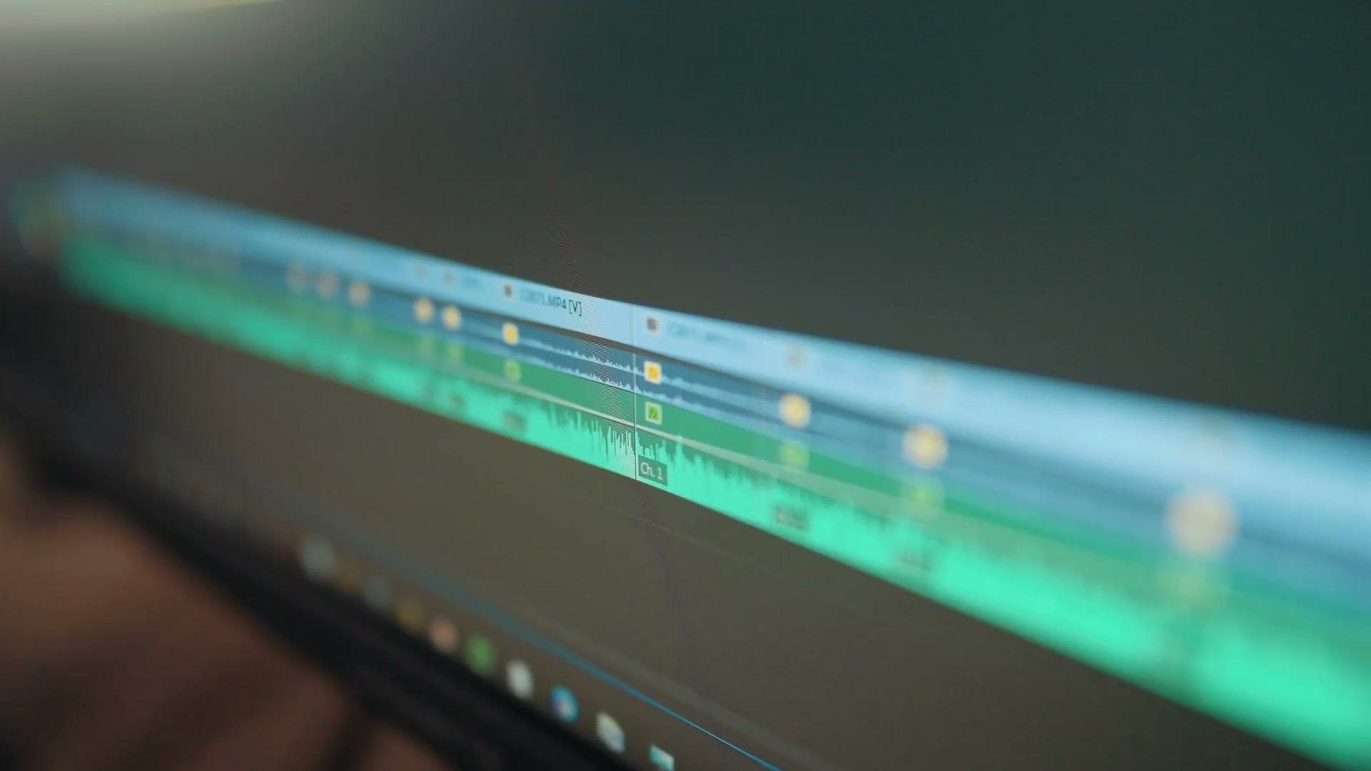 A long video editing timeline stretched across an ultrawide monitor