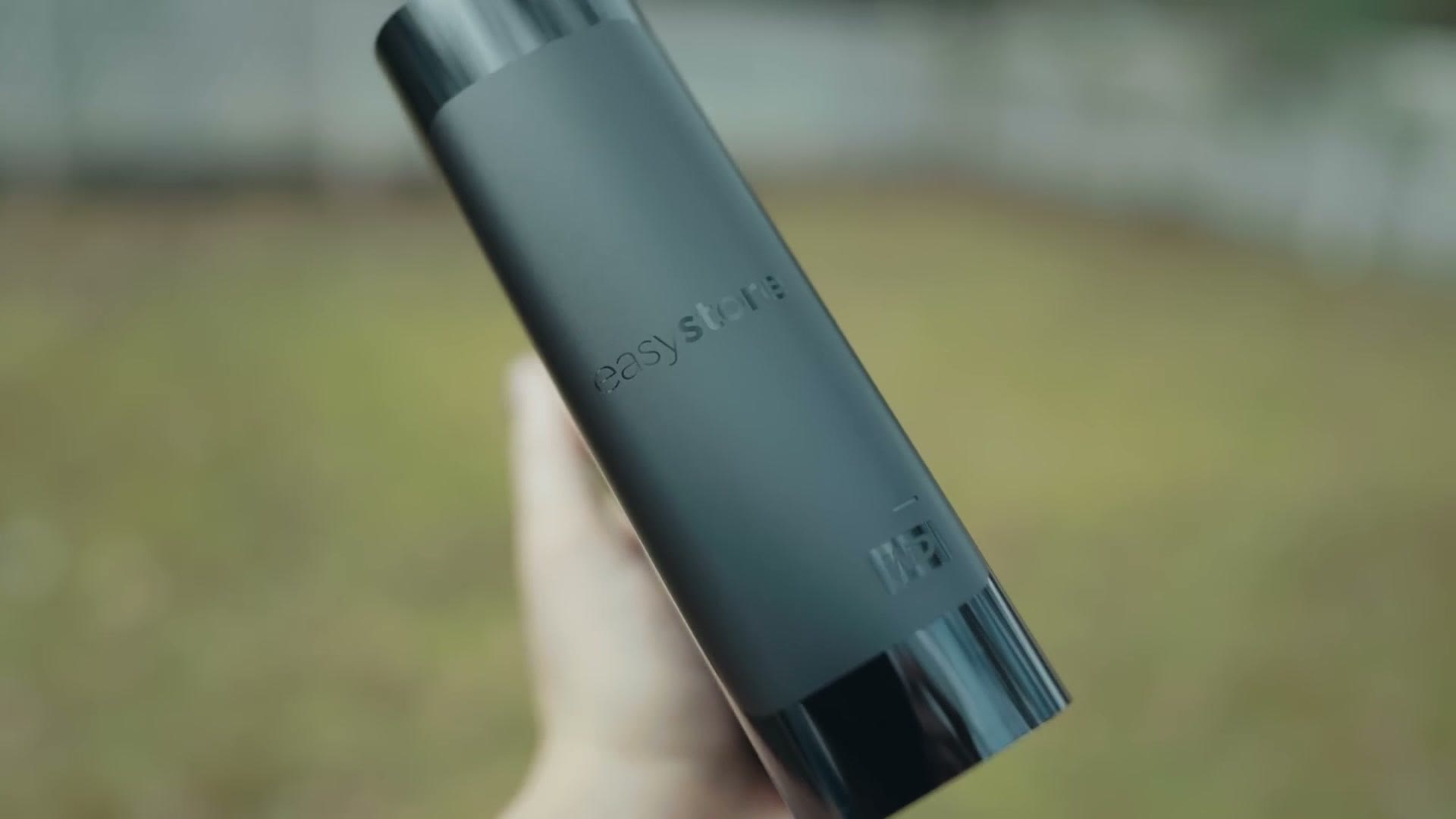 A Western Digital external drive held in hand