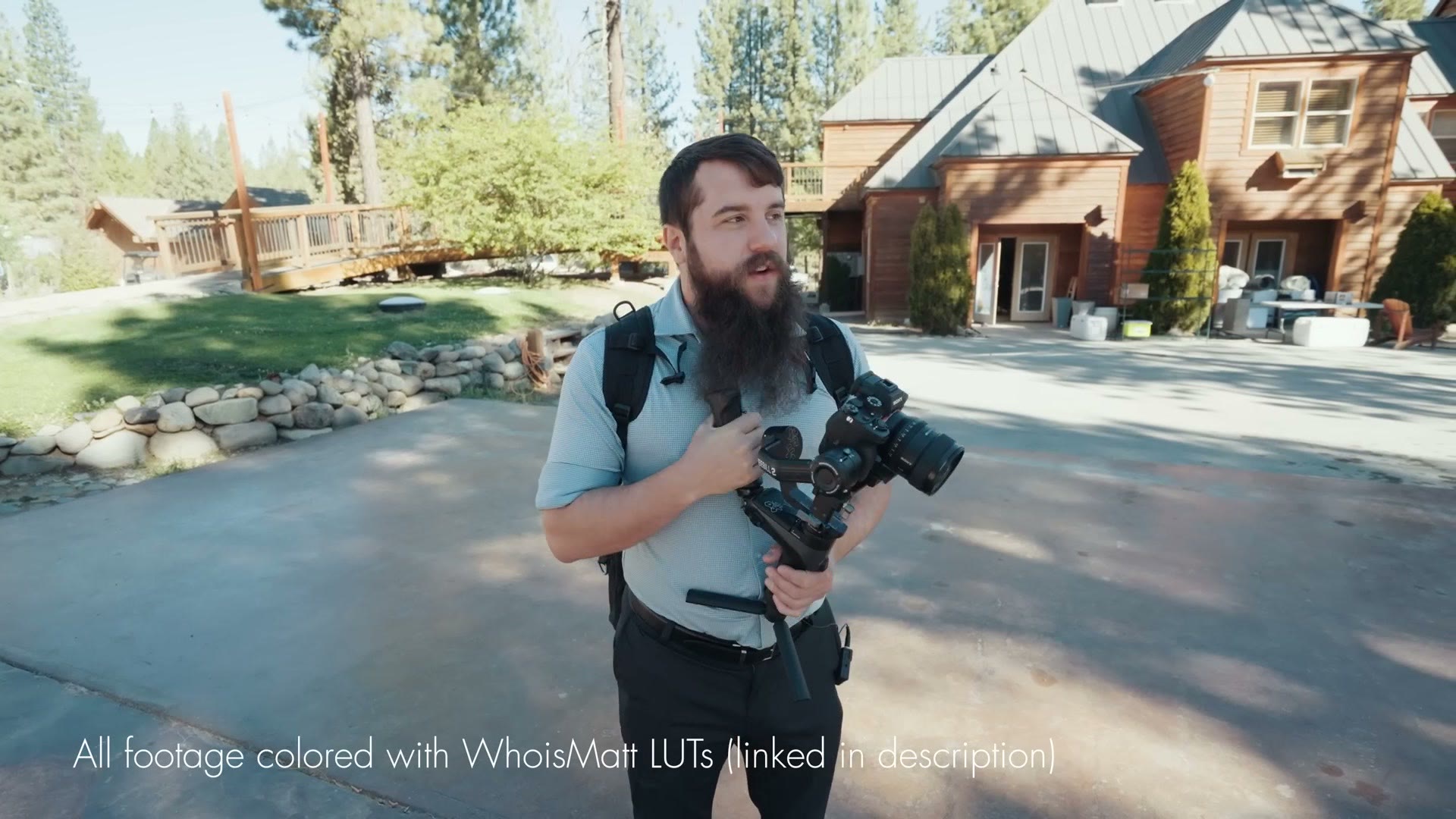 Matt Johnson standing outside the lodge with a camera on a gimbal on the morning of the wedding