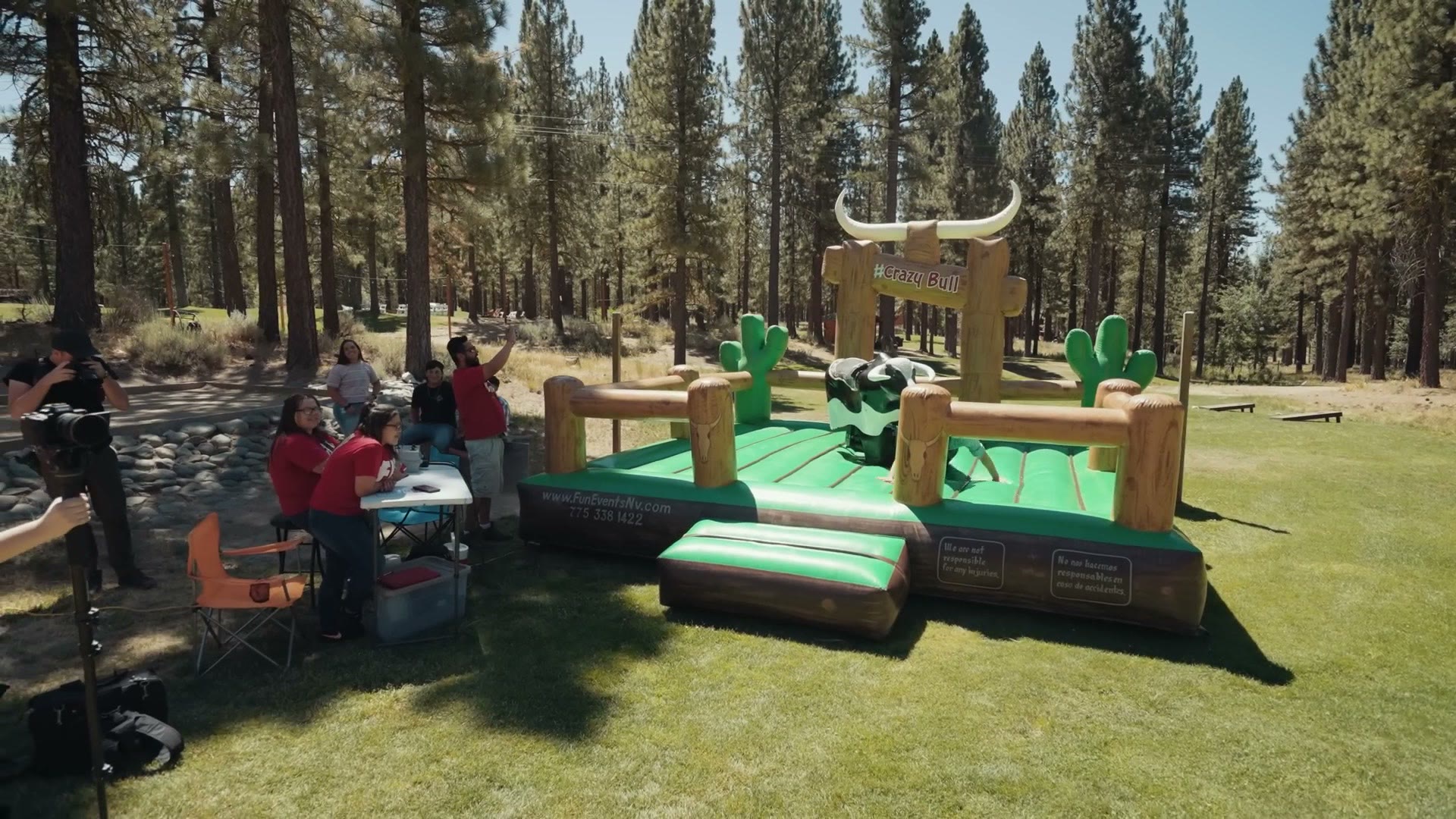 A mechanical bull set up outdoors at the wedding hoedown