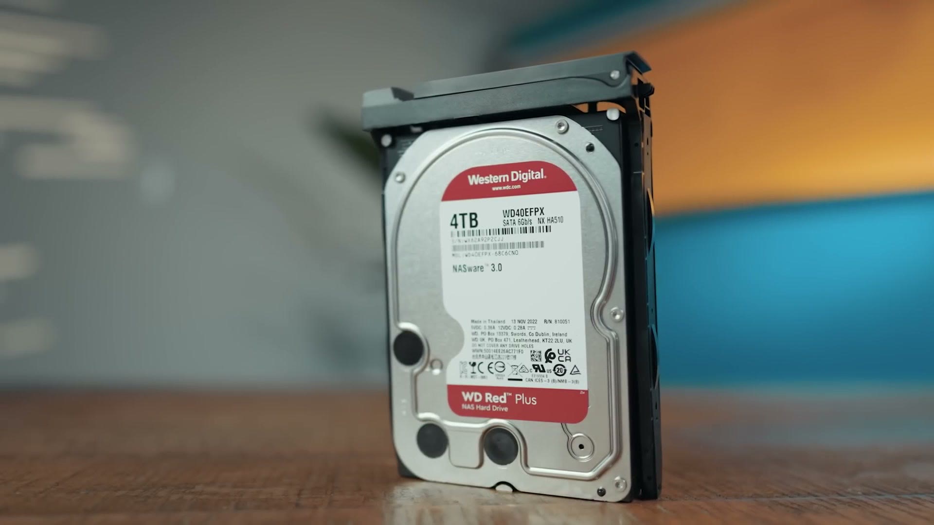 A Western Digital Red Plus 4TB hard drive standing on a table