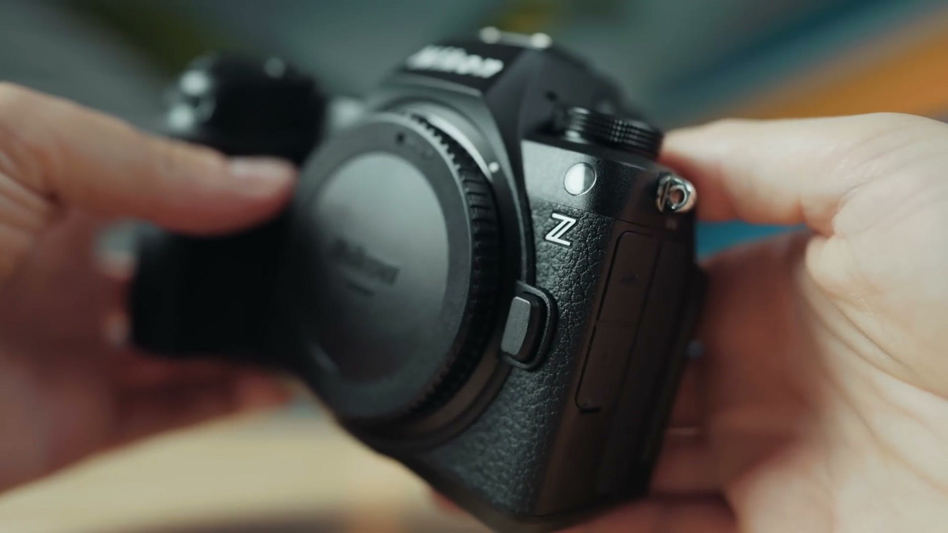 Hands holding the Nikon Z6 III camera body