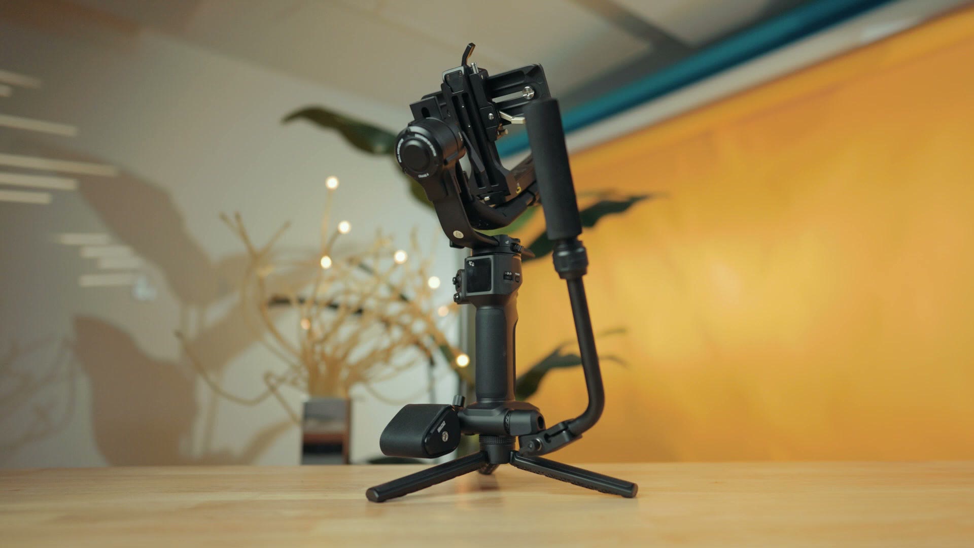 The Zhiyun Crane 4 gimbal standing on its tripod base on a table