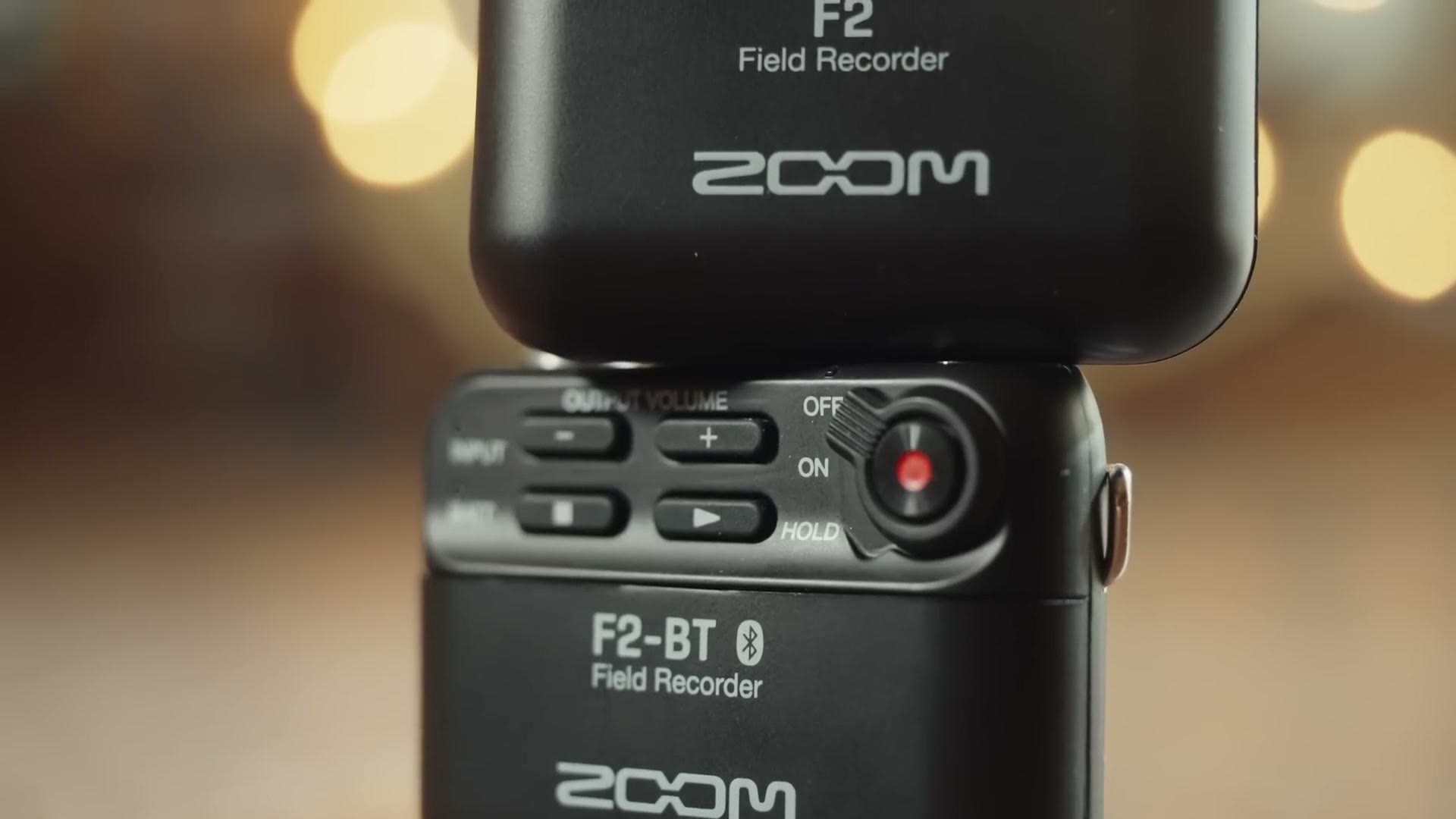 The Zoom F2 and Zoom F2-BT field recorders stacked on a table