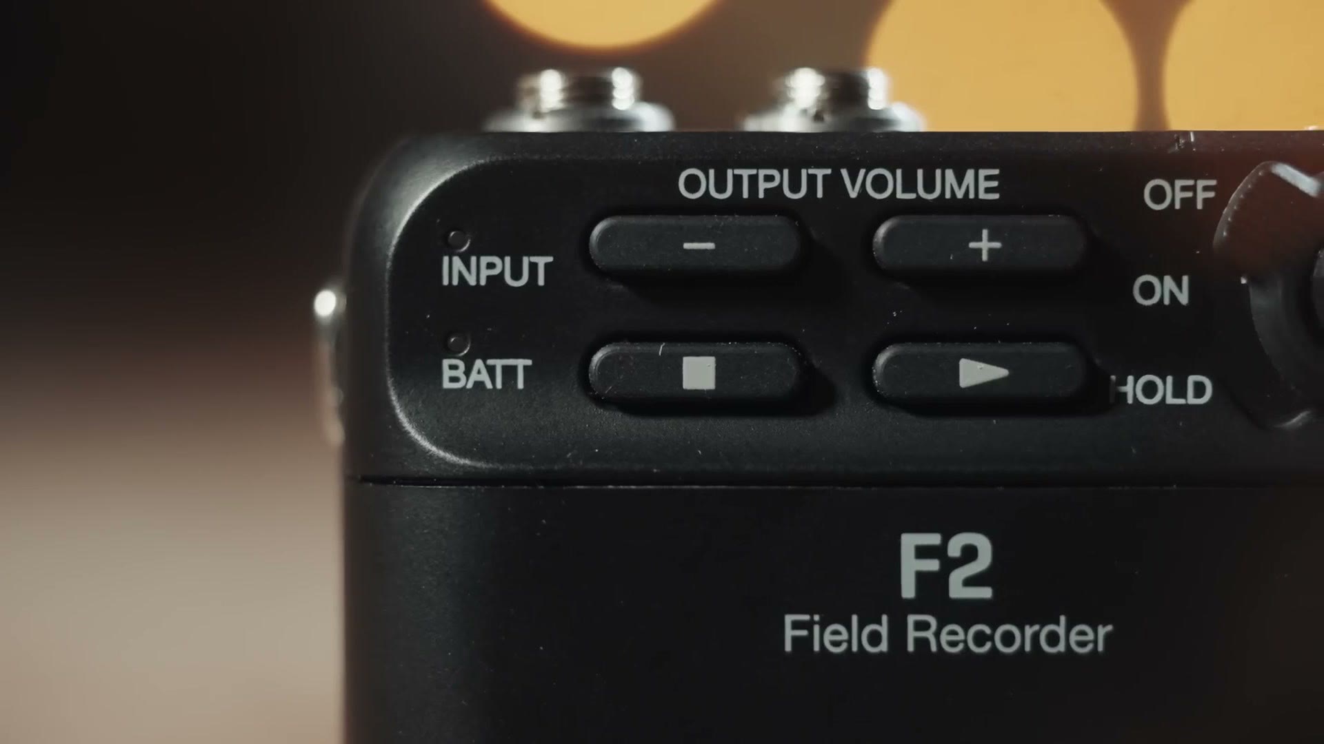 The top of the Zoom F2 showing five buttons and the off, on and hold switch