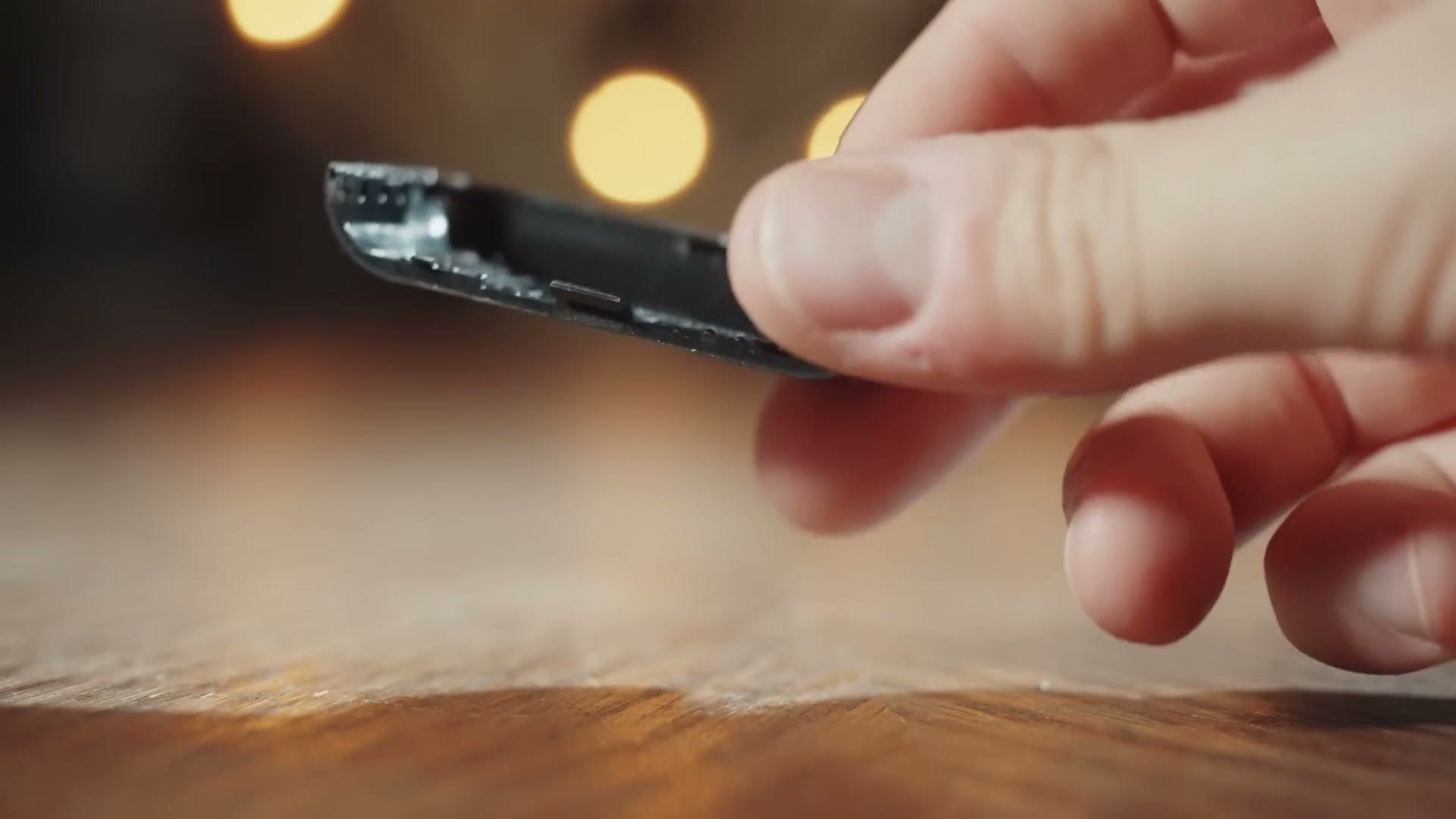The thin plastic battery door of the Zoom F2 flexing between two fingers