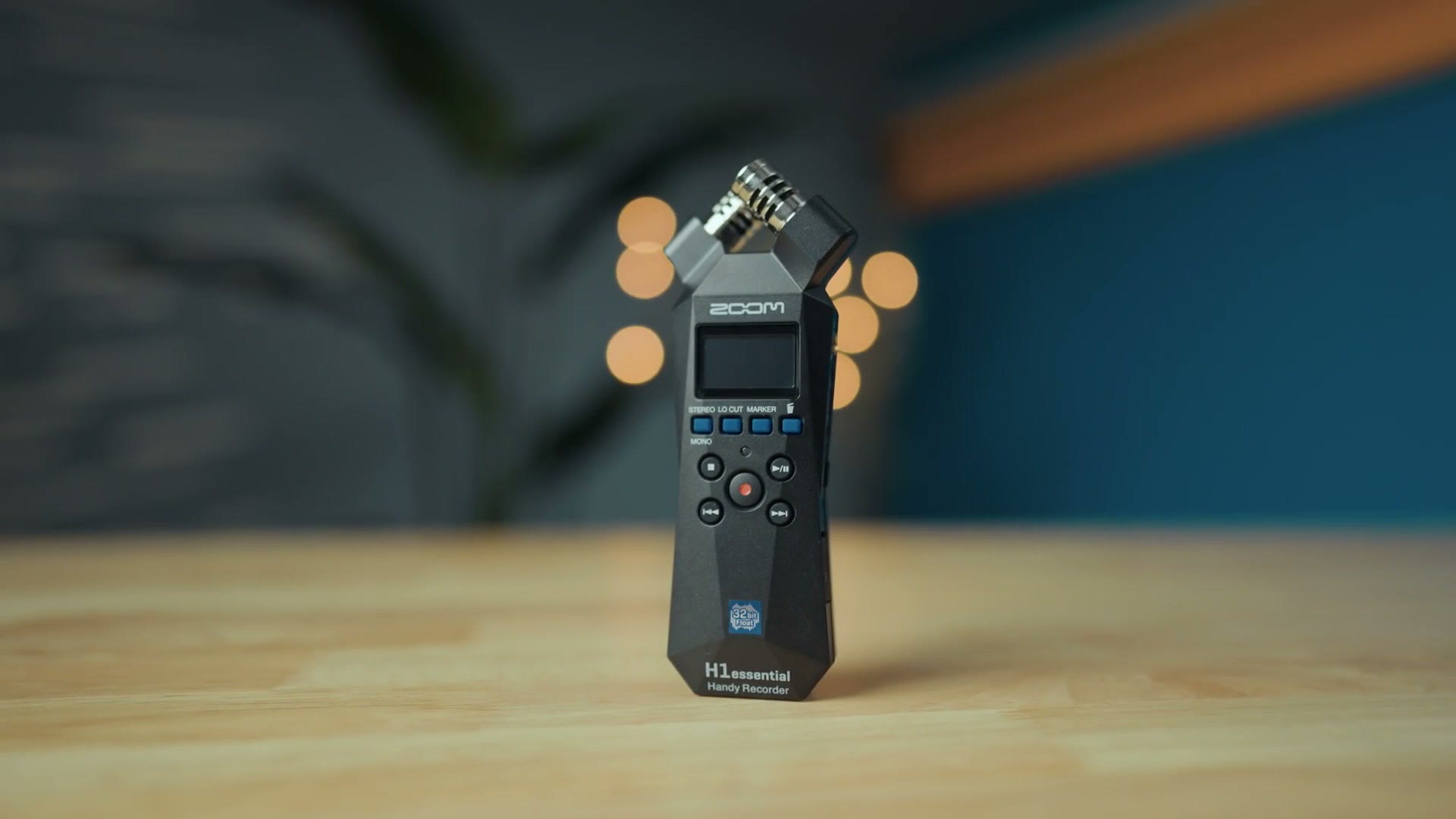 Zoom H1essential portable audio recorder on a wooden table