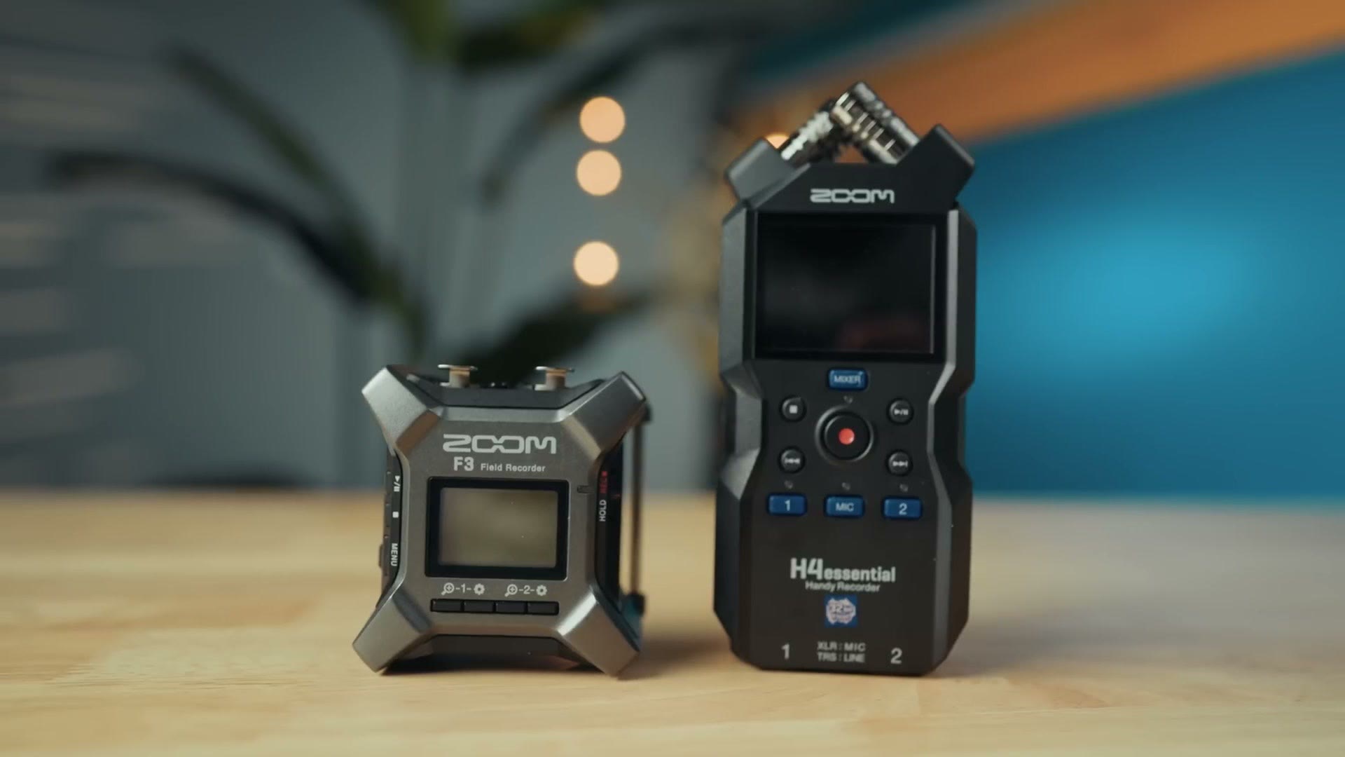 Zoom F3 field recorder next to the Zoom H4essential on a table