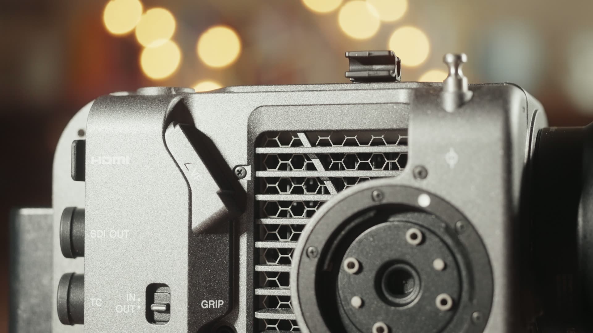Cooling fan exhaust grille and accessory rosette on the rear of a Sony FX6 cinema camera, next to the HDMI, SDI OUT and timecode ports
