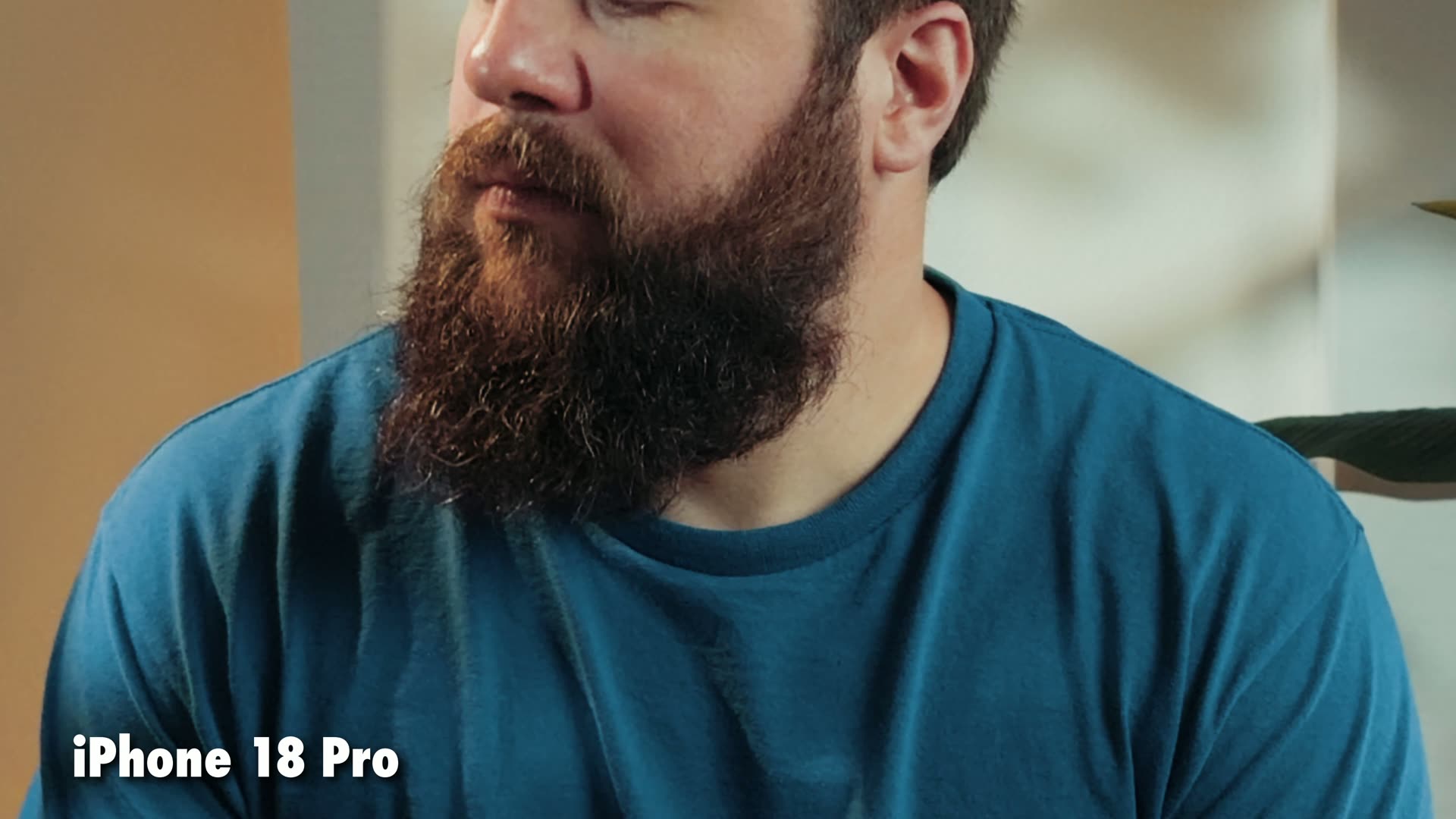 Close-up of the same bearded man filmed on the iPhone 18 Pro at F1.48, brighter and sharper
