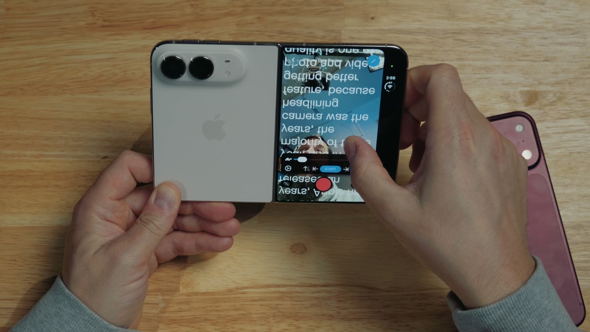 A teleprompter app on the iPhone Duo outer screen, showing script text while recording on the main camera